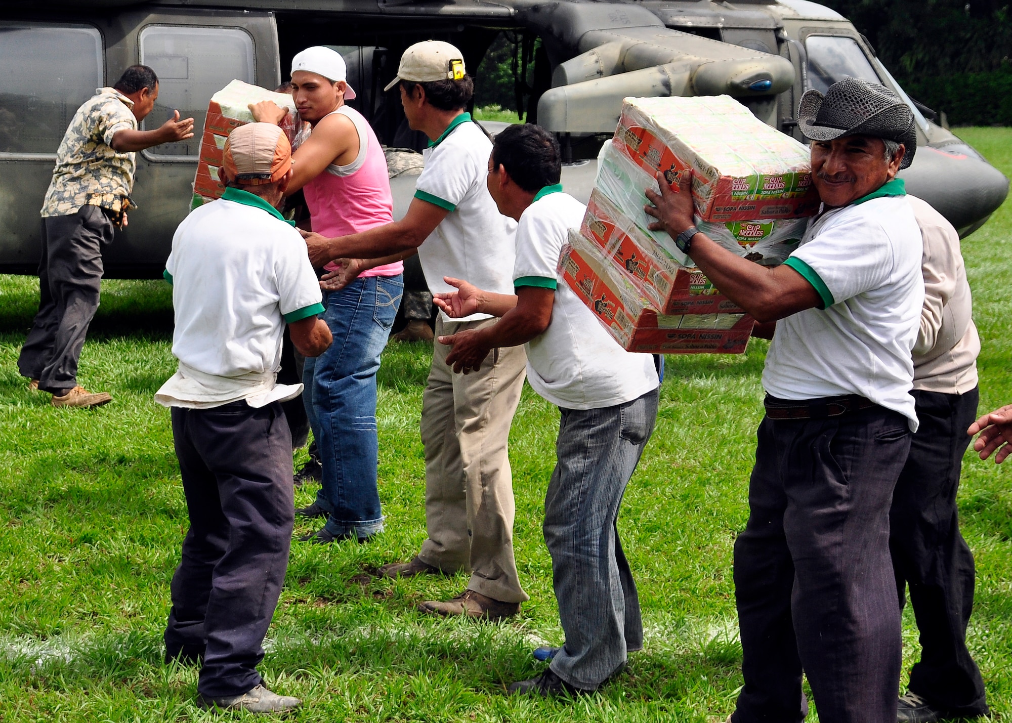 Residents of Masagua, Guatemala offload food and water from a Joint Task Force-Bravo UH-60 Blackhawk June 3. Joint Task Force-Bravo deployed four helicopters, at the request of the Guatemalan government, to support disaster relief efforts following the Pacaya Volcano eruption and Tropical Storm Agatha. Joint Task Force-Bravo’s helicopters and personnel transported nearly 53,000 pounds of relief supplies June 3-4 to Guatemalan communities in need.  (U.S. Air Force photo by Staff Sgt. Bryan Franks)
