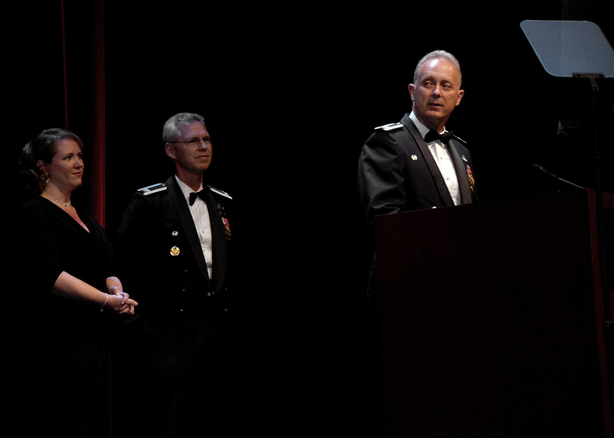 Undersecretary of the Air Force Erin C. Conaton and Col. Les Kodlick, director of Air Force Public Affairs, look on as Col. Bob Edmondson, Air Force Mortuary Affairs commander, speaks to more than four hundred public relations professionals after receiving the 2010 "Best of Silver Anvil" Award June 3, 2010, during the Public Relations Society of America's annual Silver Anvil Awards Ceremony at Equitable Tower in New York City.  (U.S. Air Force photo/Senior Airman Erik Cardenas) 