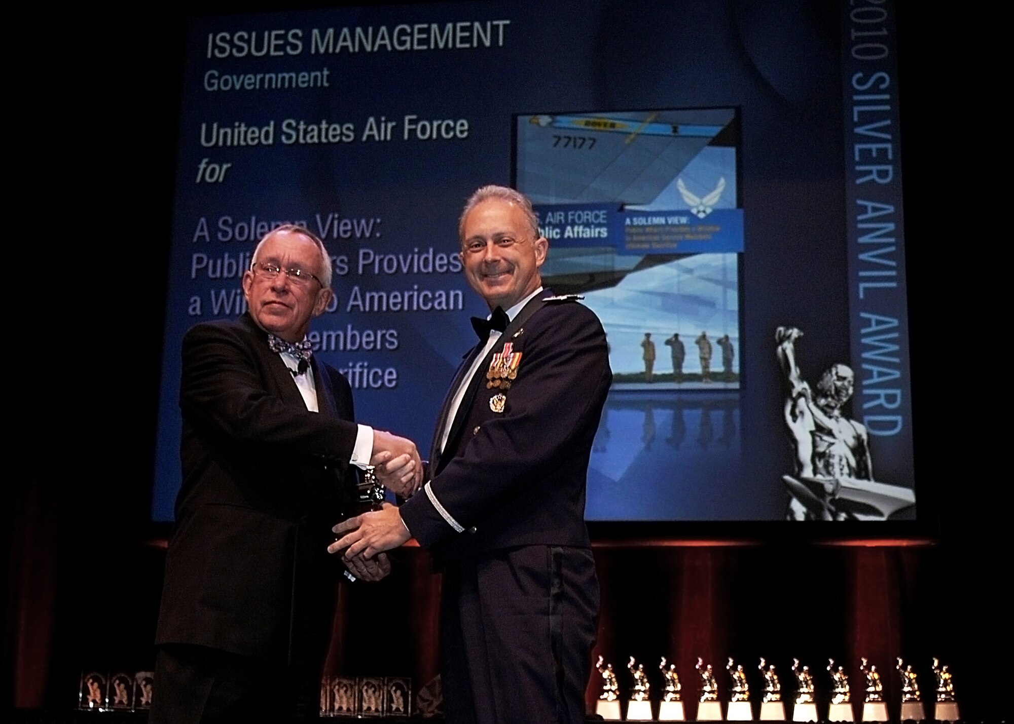 James J. Roop, Silver Anvil committee chairman, presents Col. Bob Edmondson, Air Force Mortuary Affairs commander, the Silver Anvil Award for Issues Management in the Government category June 3, 2010, during the Public Relations Society of America's annual Silver Anvil Awards Ceremony at the Equitable Tower in New York City.  (U.S. Air Force photo/Senior Airman Erik Cardenas)