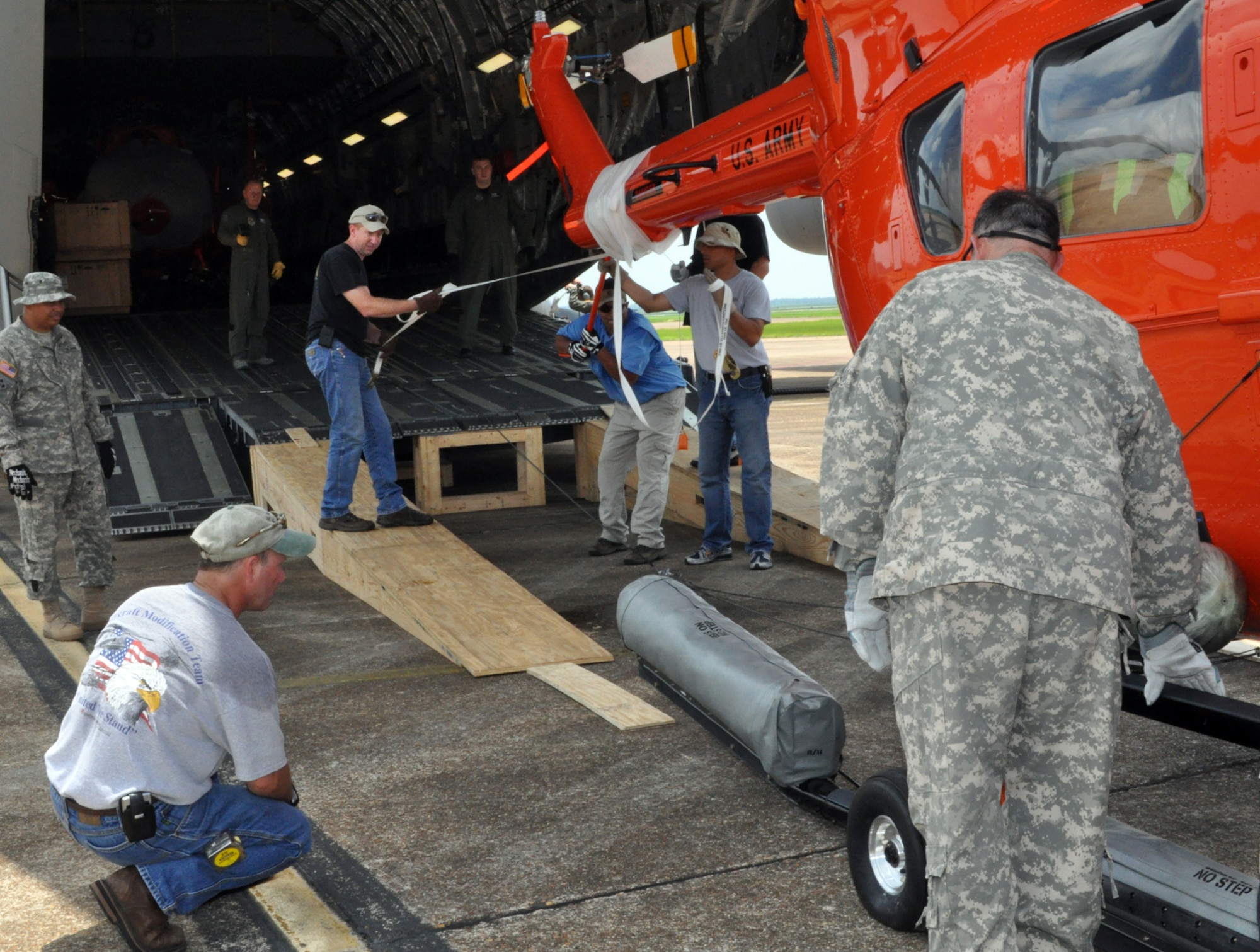 Workers watch as a UH-72 Lakota is pushed inside a C-17 Globemaster III at Columbus Air Force Base June 4. Three modified UH-72's were loaded to be delivered to U.S. Army Kawjalein Atoll/Reagan Test Site. (U.S. Air Force photo/Sonic Johnson). 