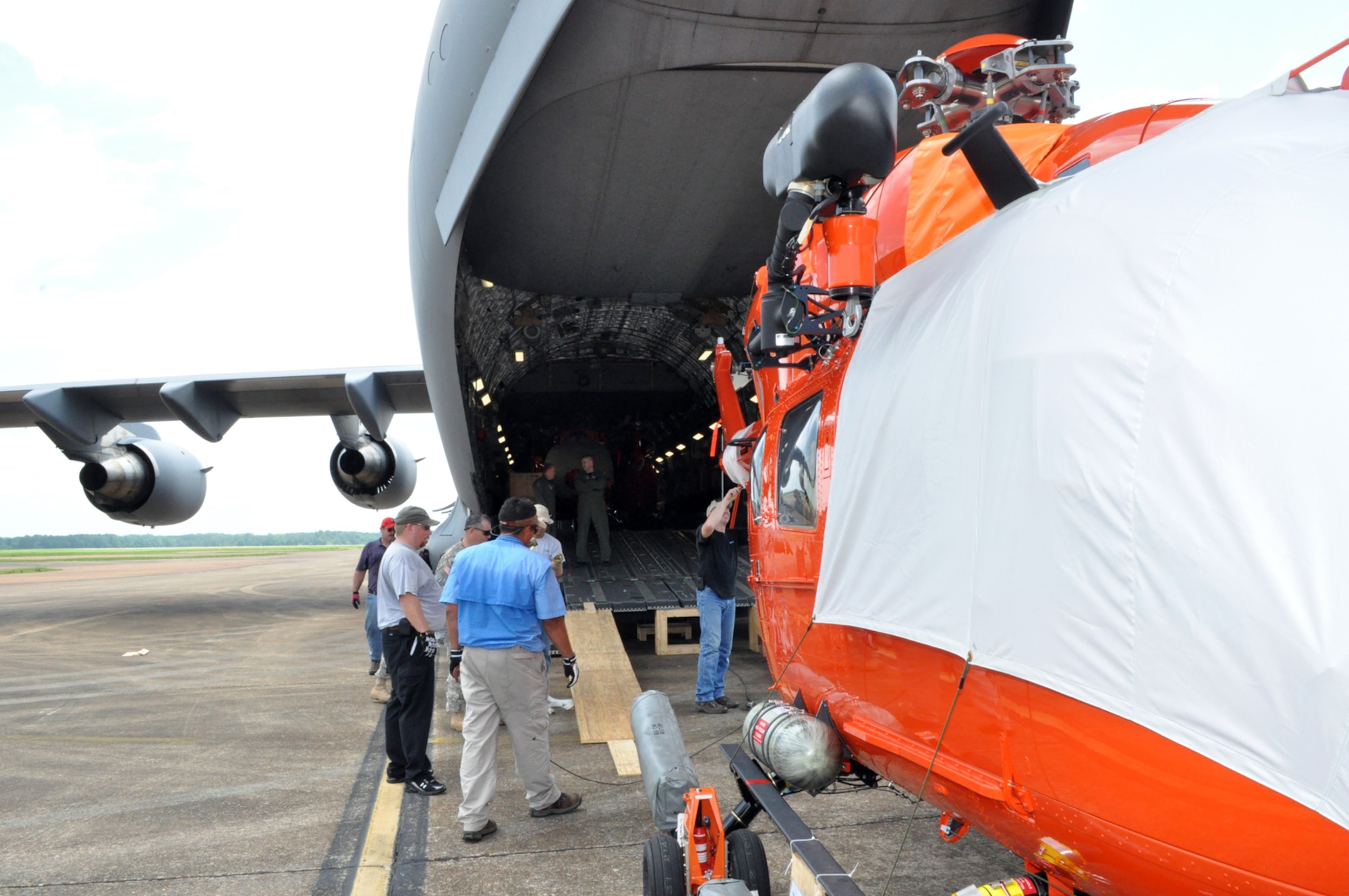 A UH-72 Lakota is pushed inside a C-17 Globemaster III at Columbus Air Force Base June 4. Three modified UH-72's were loaded to be delivered to U.S. Army Kawjalein Atoll/Reagan Test Site. (U.S. Air Force photo/Sonic Johnson). 