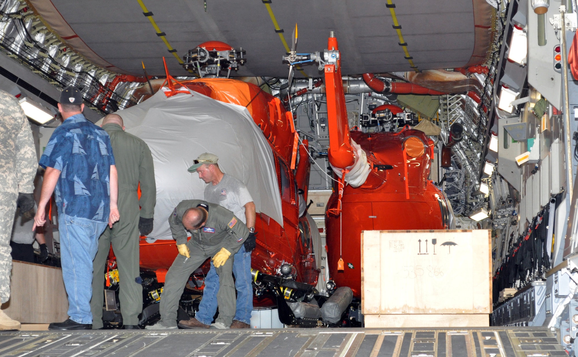 Workers secure a UH-72 Lakota inside a C-17 Globemaster III at Columbus Air Force Base. Three modified UH-72's were loaded to be delivered to U.S. Army Kawjalein Atoll/Reagan Test Site. (U.S. Air Force photo/Sonic Johnson). 
