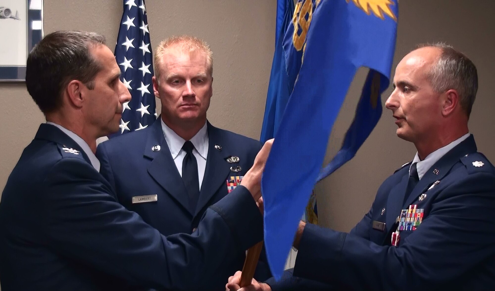 Col. Jeffrey Pennington (left), 452nd Operations Group commander, hands the flag of command to Lt. Col. Mark Davis in a change of command ceremony at March Air Reserve Base. Colonel Davis took command of the 729th Airlift Squadron from Lt. Col. Michael Hames. Colonel Hames is a pilot for Alaska Airlines and has been assigned to March since 1998. Colonel Davis was formerly assigned to Fourth Air Force and in his civilian job, is a pilot for United Airlines. He is a 1984 graduate of the U.S. Air Force Academy and lives with his wife, Tammy Gosnell, in Phoenix, Ariz. 
(U.S. Air Force photo by Master Sgt. Mike Blair)