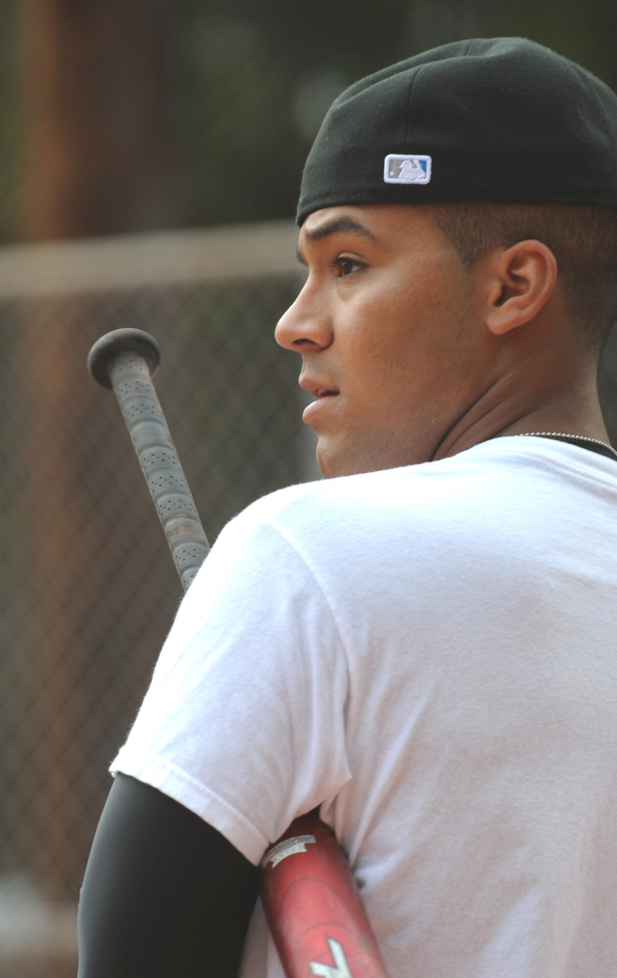 VANDENBERG AIR FORCE BASE, Calif. -- Taking a moment before going up to bat, Joel Rivera, the coach for the 381st Training Support Squadron softball team, watches his team mates play during an intramural softball game here behind the old gym Thursday, June 3, 2010.  Instructors and students from the 381st TRSS came out to show their support and play ball during the intramural softball tournament. (U.S. Air Force photo/Senior Airman Ashley Reed)