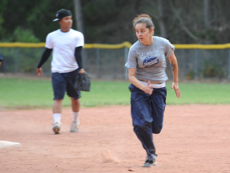 VANDENBERG AIR FORCE BASE, Calif. -- Amanda Trei, a 30th Force Support Squadron softball team member, rushes for third base during an intramural softball game here behind the old gym Thursday, June 3, 2010. Playing against the 381st Training Support Squadron for the first time, 30th FSS came out on top with a winning score of 14 - 13.  (U.S. Air Force photo/Senior Airman Ashley Reed)