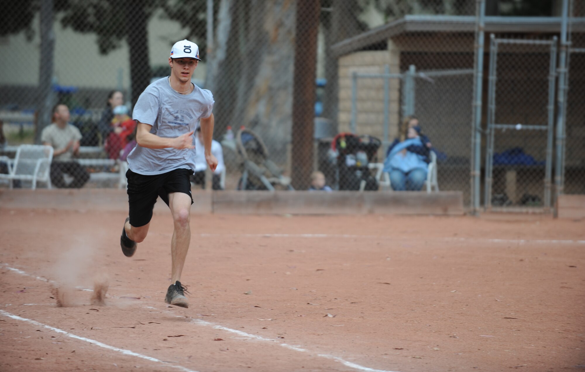 VANDENBERG AIR FORCE BASE, Calif. -- Jonathon Trei, a 30th Force Support Squadron softball team member, runs to first base during an intramural softball game here behind the old gym Thursday, June 3, 2010. Playing against the 381st Training Squadron for the first time, 30th FSS came out on top with a winning score of 14 - 13. (U.S. Air Force photo/Senior Airman Ashley Reed)