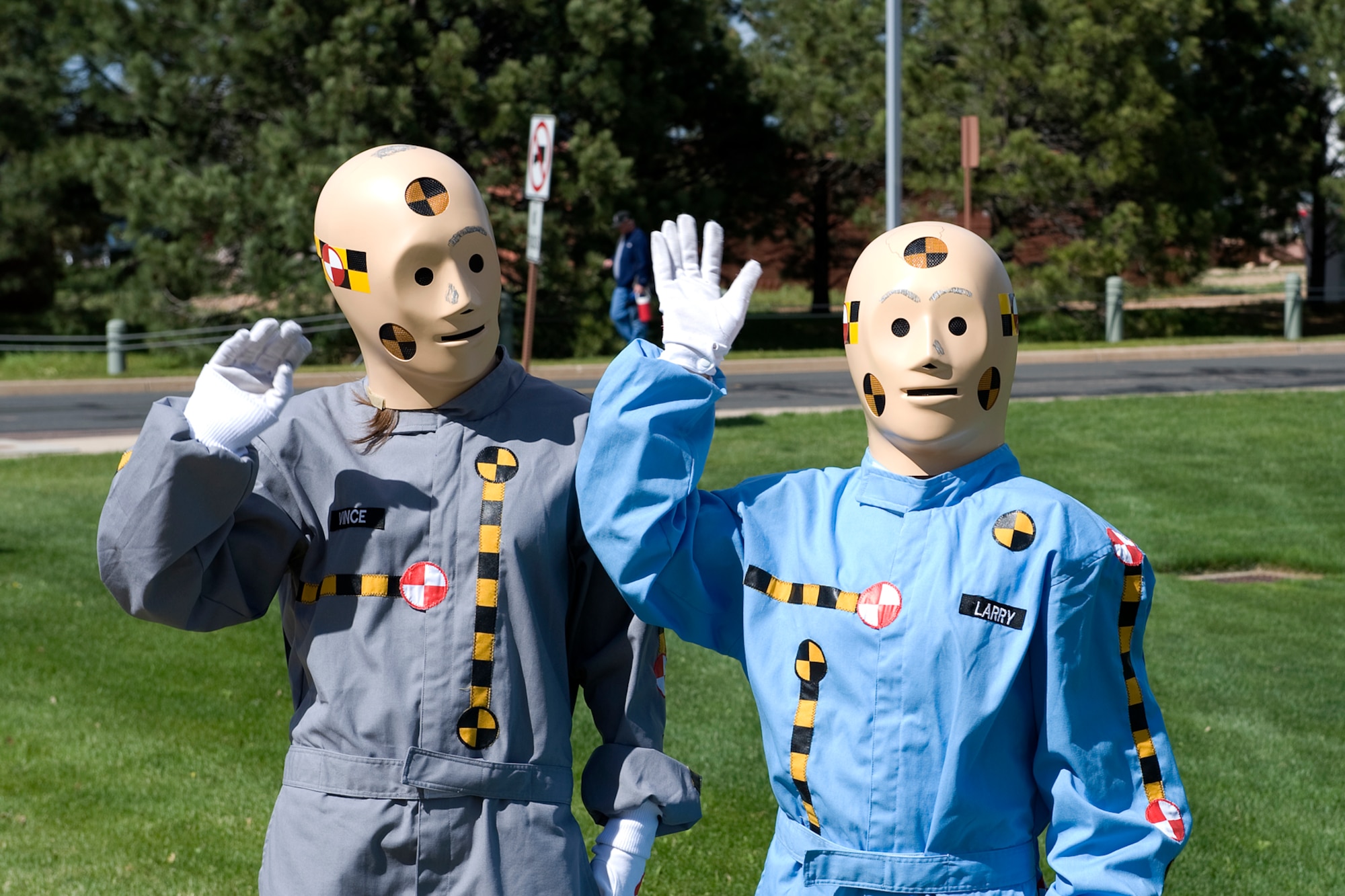 PETERSON AIR FORCE BASE, Colo. -- Crash test dummies Vince and Larry (Katelyn Smith, in the gray suit and Rae Reeves in the blue suit), wave at Team Pete personnel as they leave the north gate May 27 on Peterson Air Force Base. The crash dummies were out to remind drivers, “Don’t leave safety at the gate,” as they drove off to a four-day weekend for Memorial Day, which is the start of the Air Force 101 Critical Days of Summer safety campaign. Last summer, the 21st Space Wing had 18 reported mishaps and 17 percent of those were private motor vehicle accidents. The 101 Critical Days of Summer safety campaign runs now to Labor Day weekend. (U.S. Air Force photo/Craig Denton)
