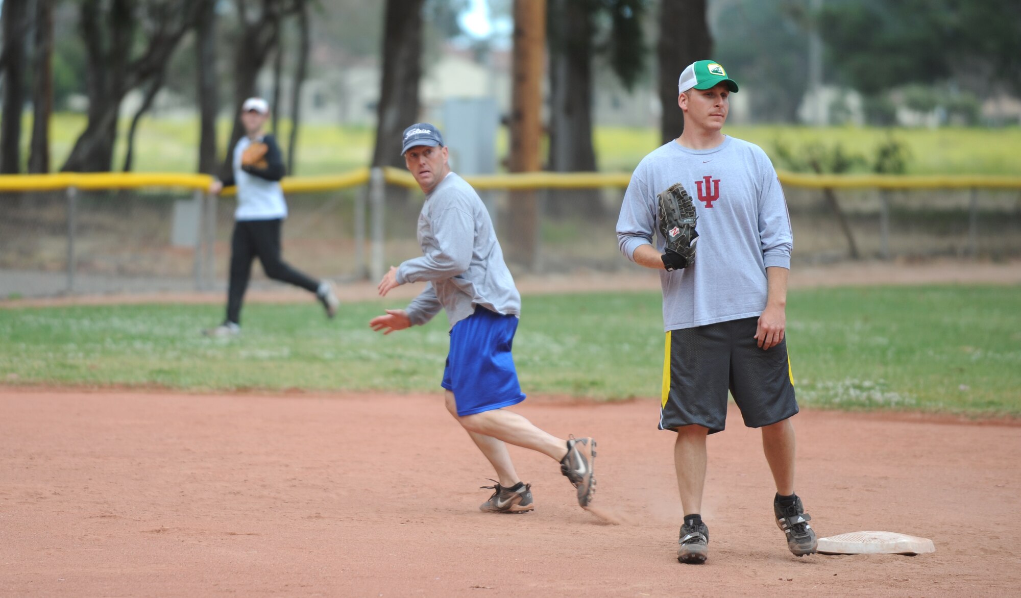 VANDENBERG AIR FORCE BASE, Calif. -- Attempting to steal third base, Tracy Watkins, a member of the 30th Force Support Squadron softball team, sneaks past the shortstop during an intramural softball game here behind the old gym Thursday, June 3, 2010. Playing against the 381st Training Support Squadron for the first time, 30th FSS came out on top with a winning score of 14 - 13. (U.S. Air Force photo/Senior Airman Ashley Reed)
