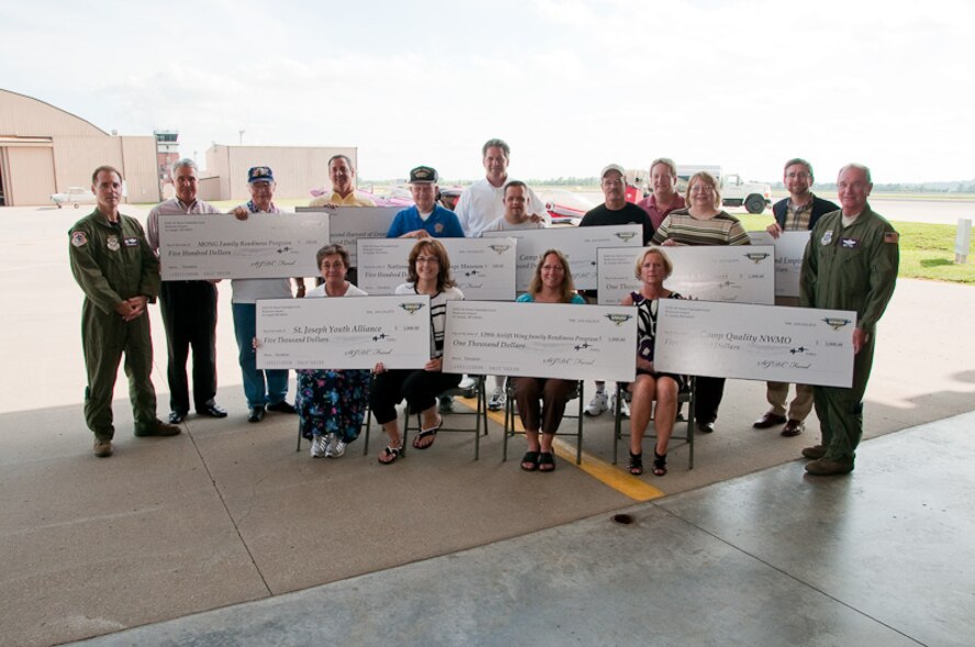 Members of the 139th Airlift Wing and St. Joseph community leaders come together to award donations collected at the Sound of Speed Air Show on June 2, 2010. The Sound of Speed Air Show was hosted at Rosecrans Air National Guard base in May, 2010. (U.S. Air Force photo by Master Sgt. Shannon Bond) (RELEASED)