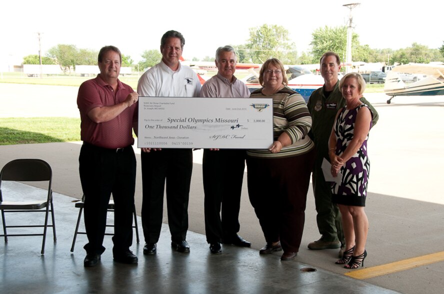 Members of the 139th Airlift Wing and St. Joseph community leaders come together to award donations collected at the Sound of Speed Air Show on June 2, 2010. The Sound of Speed Air Show was hosted at Rosecrans Air National Guard base in May, 2010. (U.S. Air Force photo by Master Sgt. Shannon Bond) (RELEASED)