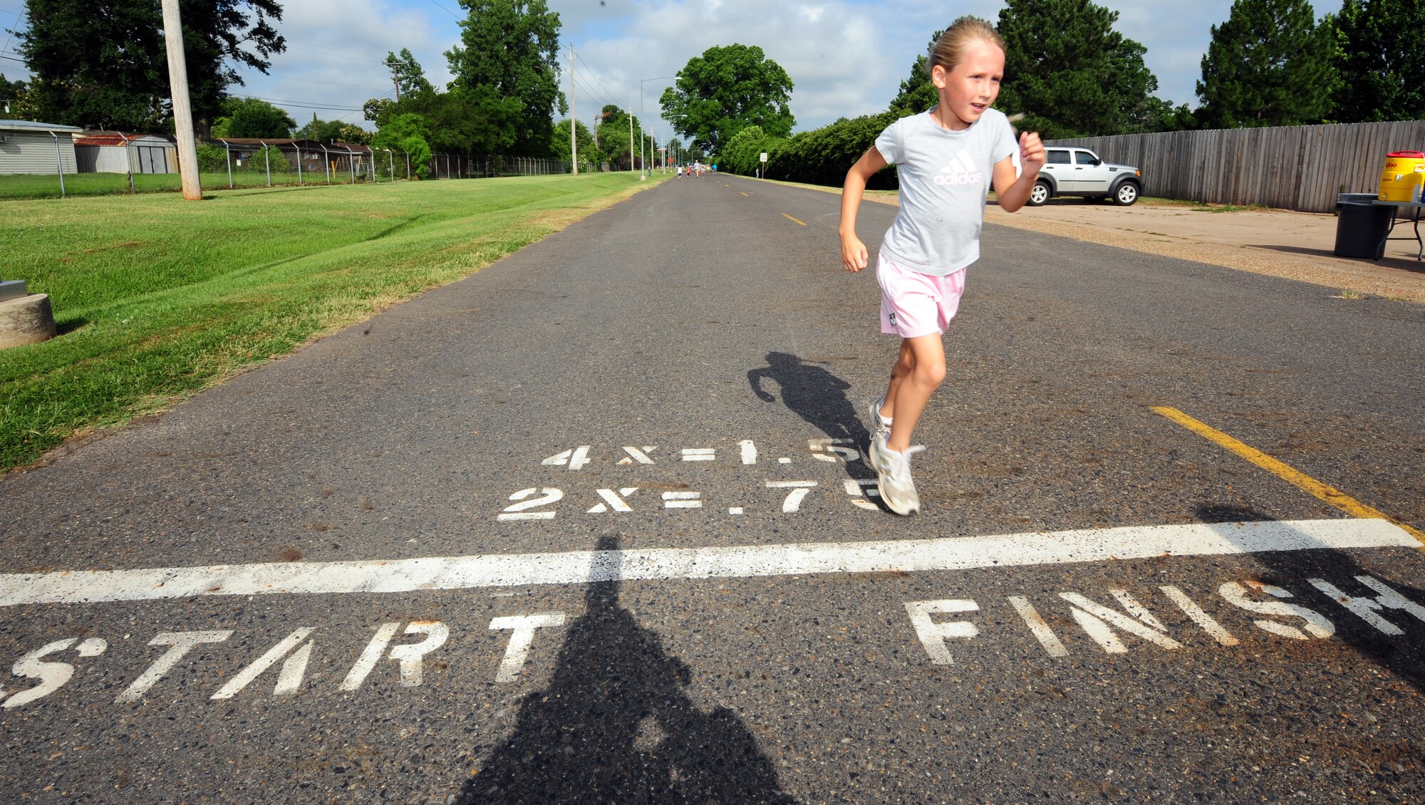 BARKSDALE AIR FORCE BASE, La. – Alaina Corey, 6, daughter of Capt. Scott Corey from the 2d Medial Support Squadron, crosses the finish line in third place for her age group during the America’s Armed Forces Kids Run held outside the fitness center June 4. Alaina participated in the half-mile run while older children participated in one-mile and two-mile courses. The kids run was held to help promote Fit Factor, a youth fitness initiative that encourages children to be physically active every day and make healthy eating and lifestyle choices. (U.S. Air Force photo by Senior Airman Joanna M. Kresge)