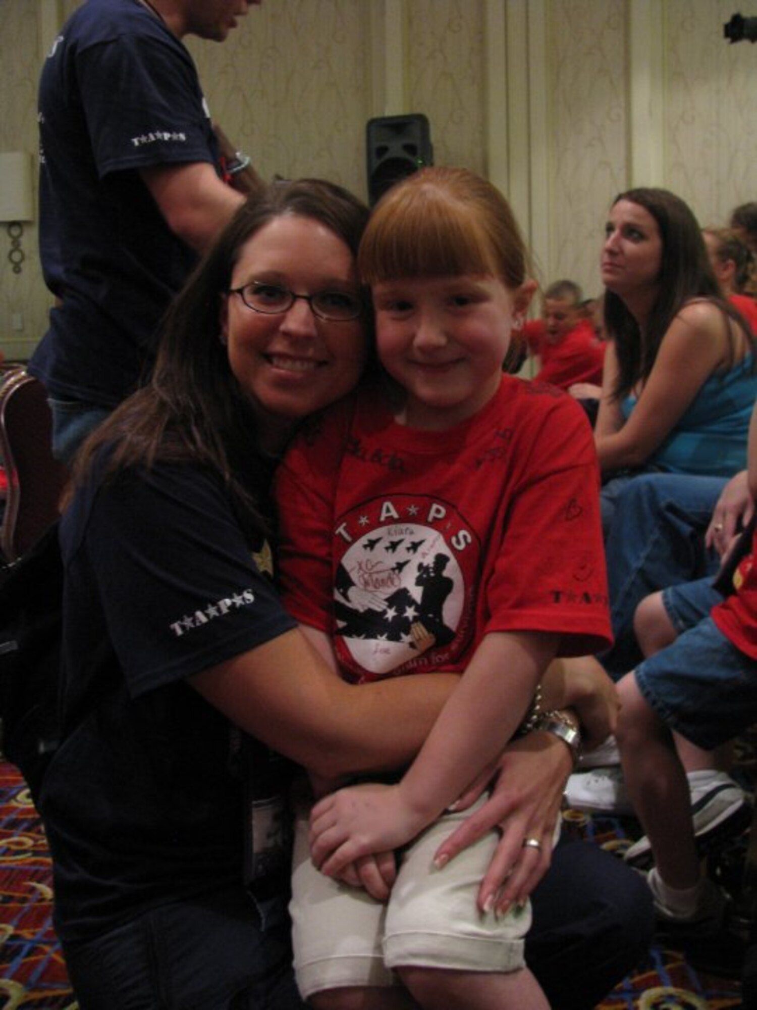 Staff Sgt. Mandi Hagen, from the 119th Wing, North Dakota Air National Guard hugs her mentee during the Tragedy Assistance Program for Survivors (TAPS) at a Good Grief Camp on May 29 in Washington, D.C.  This is Hagen’s fourth year volunteering her personal time and money to take part in the camp that focuses on helping children of military families who have lost loved ones.   Hagen is one of five Airmen from the North Dakota Air National Guard who participated in the Good Grief Camp this year.