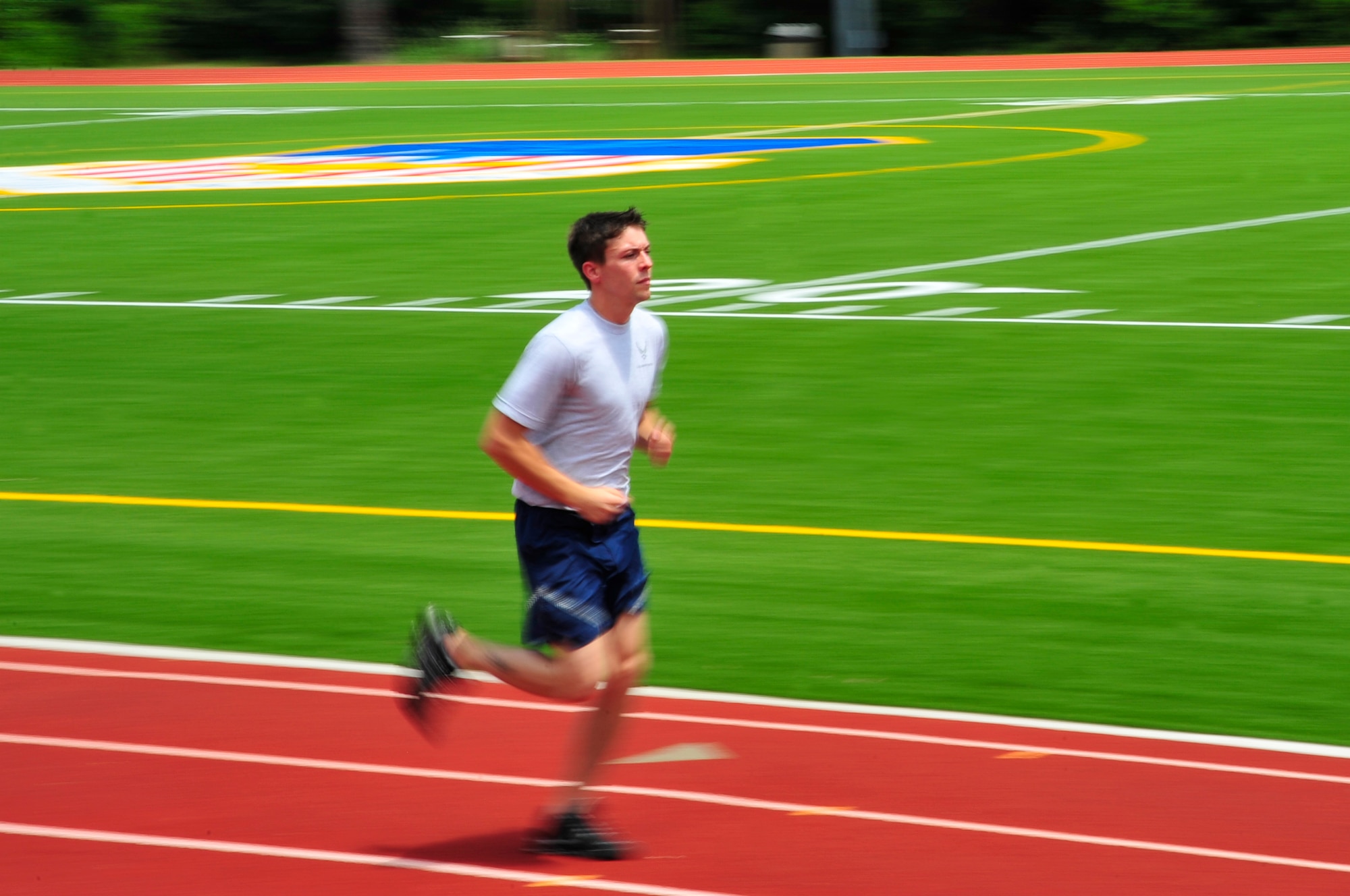 Senior Airman Dustin Zeillemaker, 4th Aircraft Maintenance Unit communications navigation technician, runs on the newly opened Aderholt Track after its reopening ceremony June 4.  The track and field replaced the concrete track and grass field with a rubberized running track and professional grade astro-turf designed to provide lower-impact running. (DoD photo by Air Force Senior Airman Sheila deVera)