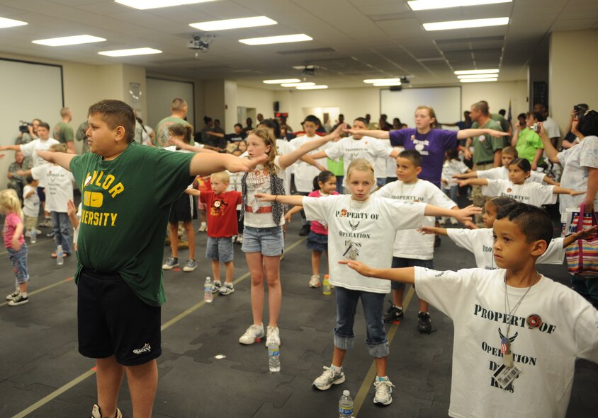 DYESS AIR FORCE BASE, Texas-- Children of Dyess Airmen do physical training during Operation Dyess Kids June 4 here.  The purpose of Operation Dyess Kids was to help the children understand why parents deploy and what they go through during a deployment, as well as to encourage parent-child communication. The program aimed to ease some of the tension children have about their parents' deployments, which allows the deployers to focus on the mission.(U.S Air Force photo/ Airman 1st Class Shannon Hall)