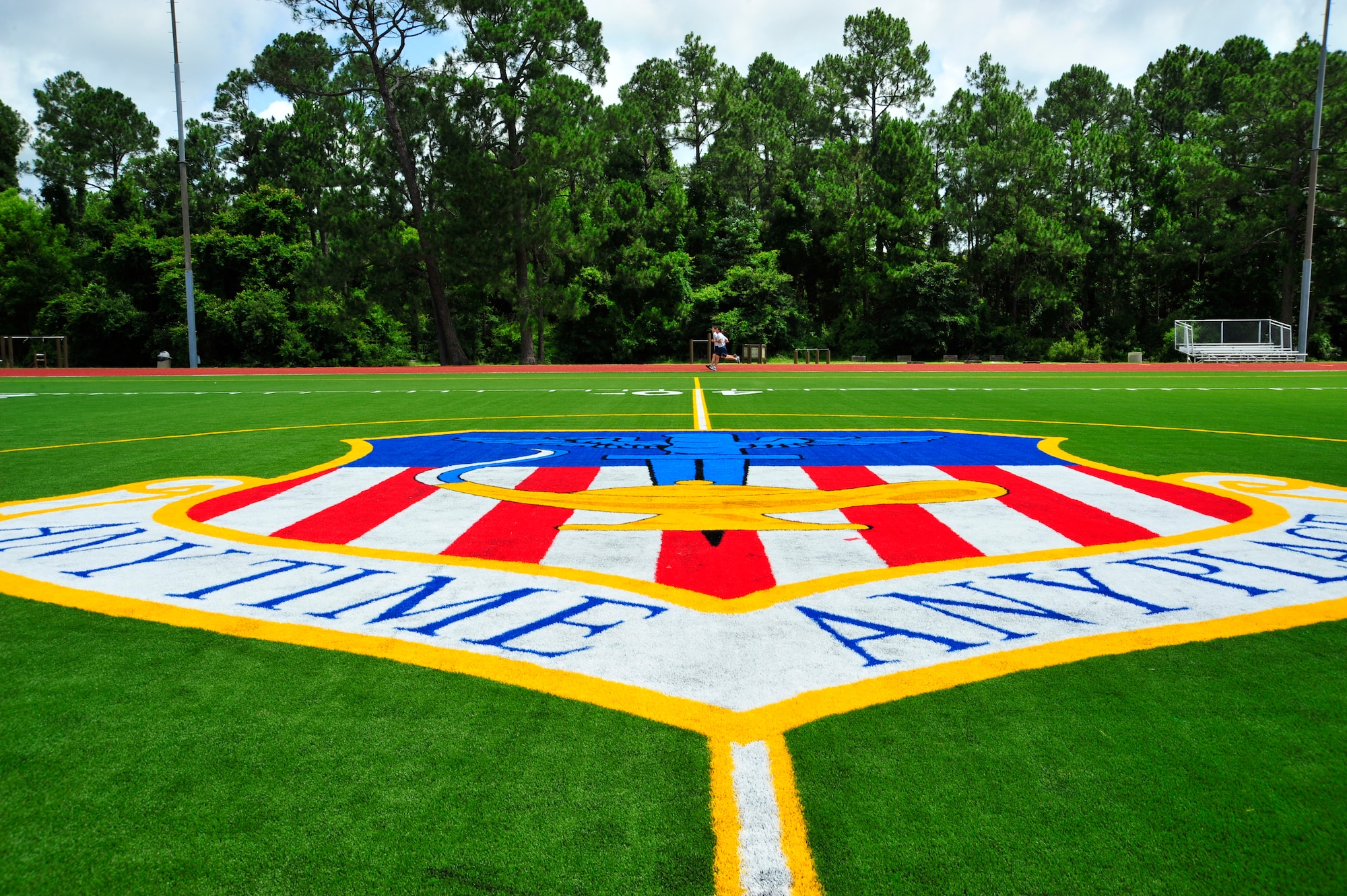Airman 1st Class Stephen Jacinto, Staff Sgt. Michelle Fleet and Senior Airman Dustin Zeillemaker run on the newly opened Aderholt Track after its reopening ceremony June 4.  The track and field replaced the concrete track and grass field with a rubberized running track and professional grade astro-turf designed to provide lower-impact running. (DoD photo by Air Force Senior Airman Sheila deVera)