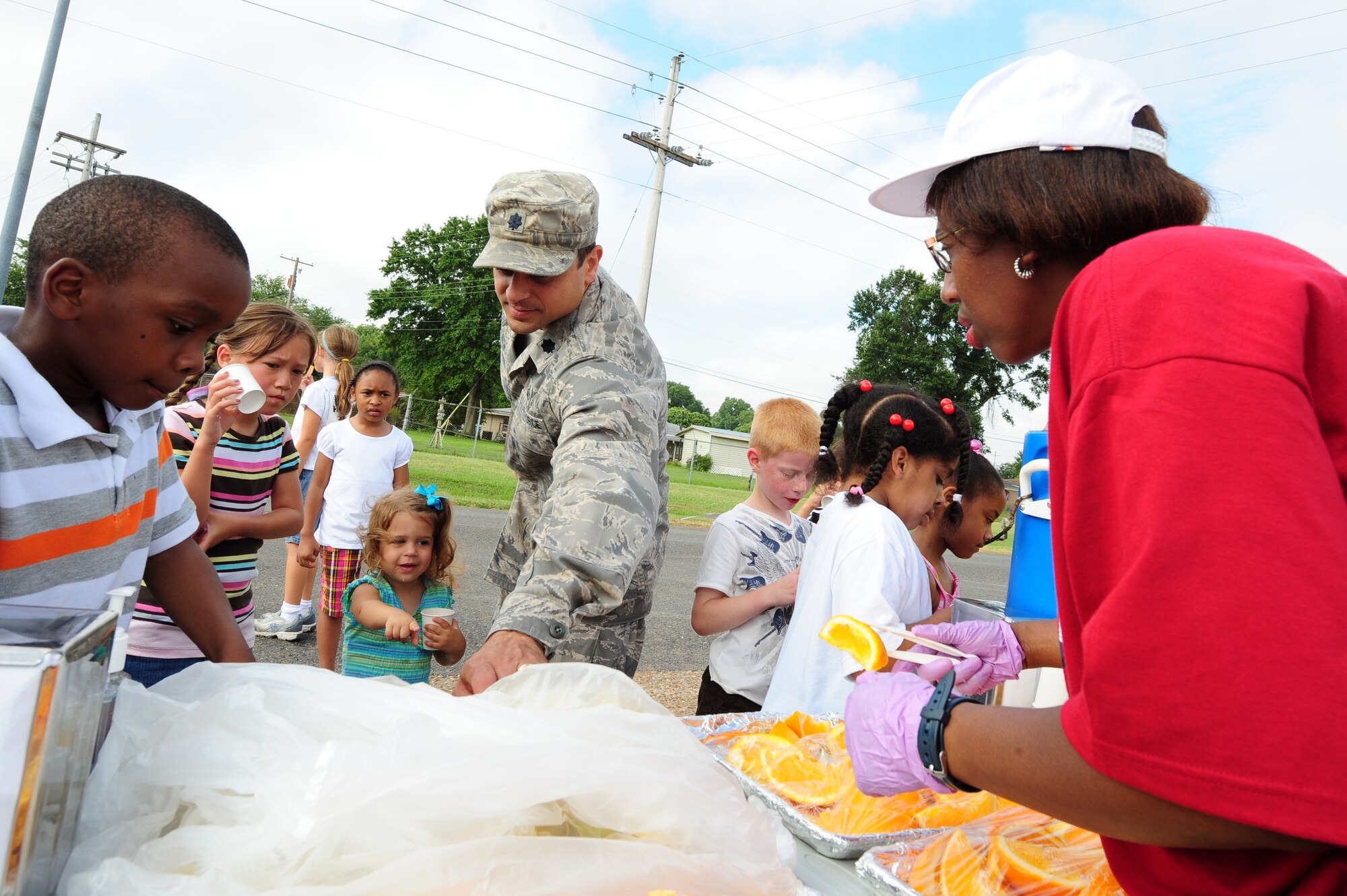 BARKSDALE AIR FORCE BASE, La. – Lt. Col. Anthony Sansano, 2d Force Support Squadron commander, takes a banana from the refreshment table for his daughter Glory following the America’s Armed Forces Kids Run held outside the fitness center June 4. The kids run was held to help promote Fit Factor, a youth fitness initiative that encourages children to be physically active every day and make healthy eating and lifestyle choices. (U.S. Air Force photo by Senior Airman Joanna M. Kresge)