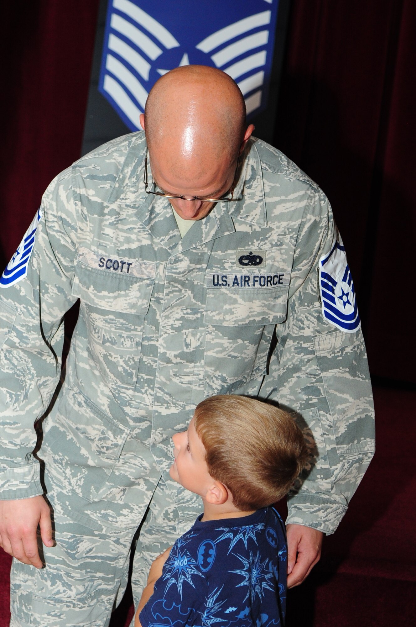 BARKSDALE AIR FORCE BASE, La. – Tech. Sgt. Charles Scott, 2d Maintenance Group, hugs his son during the master sergeant selection party at the Stripes Club June 3. This cycle more than 75 technical sergeants from Barksdale were selected for promotion to master sergeant. (U.S. Air Force photo by Senior Airman Joanna M. Kresge)
