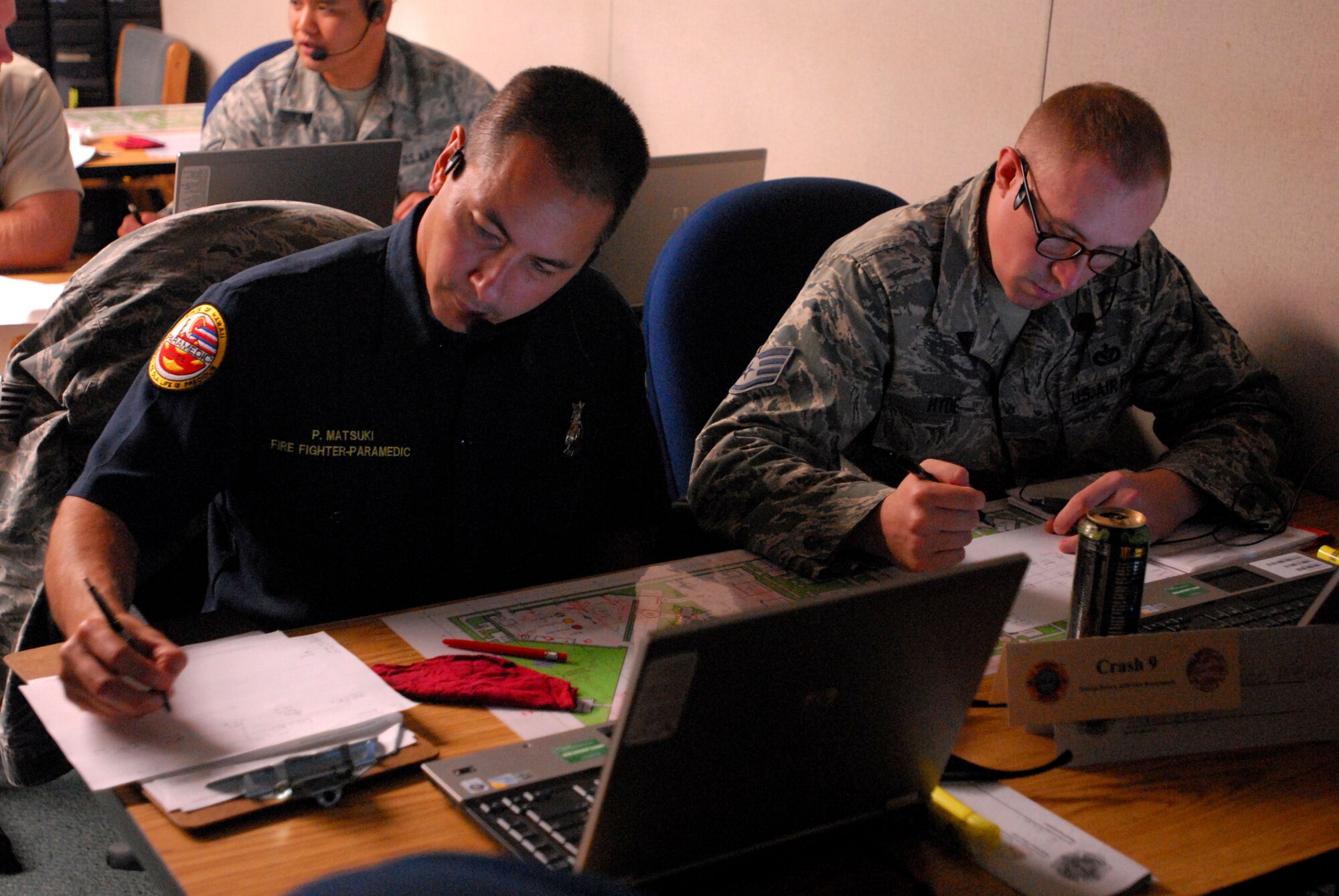 JOINT BASE PEARL HARBOR HICKAM, Hawaii - Firefighters of the Federal Fire Department Hawaii and the Hickam Fire Department work out a virtual scenario on the Norma Brown trainer here, Jun 1. The Norma Brown trainer isa realistic situational training software used as part of a 12-day Fire Officer Two Course. The command and control training involved both the Hickam firefighters and Federal Fire Department Hawaii firefighters from Pearl Harbor. (U.S. Air Force photo/Senior Airman Gustavo Gonzalez)

