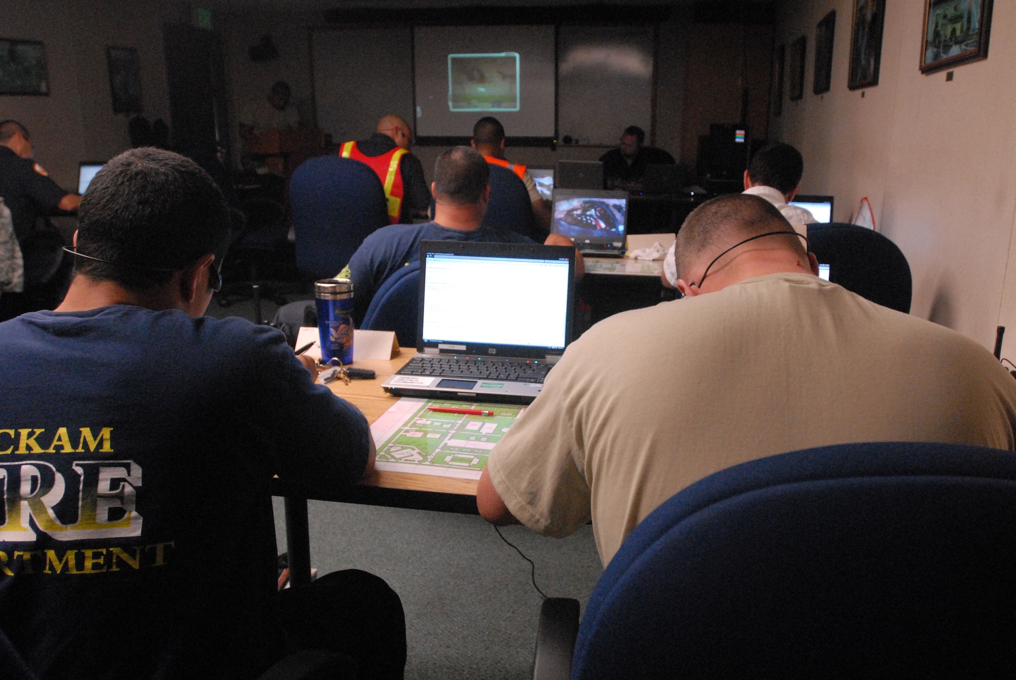 JOINT BASE PEARL HARBOR HICKAM, Hawaii - Firefighters of the Federal Fire Department Hawaii and the Hickam Fire Department work out a virtual scenario on the Norma Brown trainer here, Jun 1. The Norma Brown trainer isa realistic situational training software used as part of a 12-day Fire Officer Two Course. The command and control training involved both the Hickam firefighters and Federal Fire Department Hawaii firefighters from Pearl Harbor. (U.S. Air Force photo/Senior Airman Gustavo Gonzalez)

