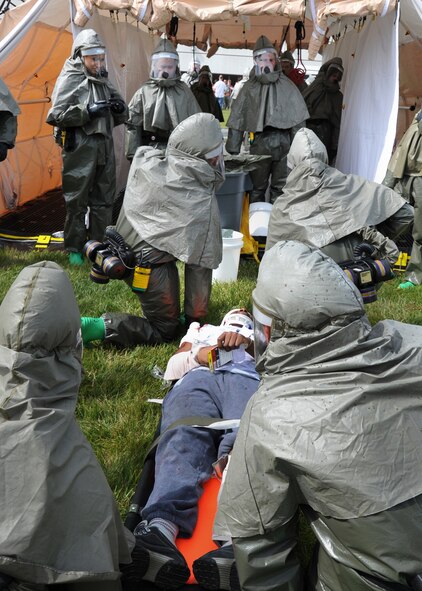 60th Medical Group personal decontaminate the simulated injured during an emergency response exercise at Travis Air Force Base, California on 12 May 2010 prior to entering David Grant Medical Center for further medical treatment. (U.S. Air Force photo by Civ/Jay Trottier)