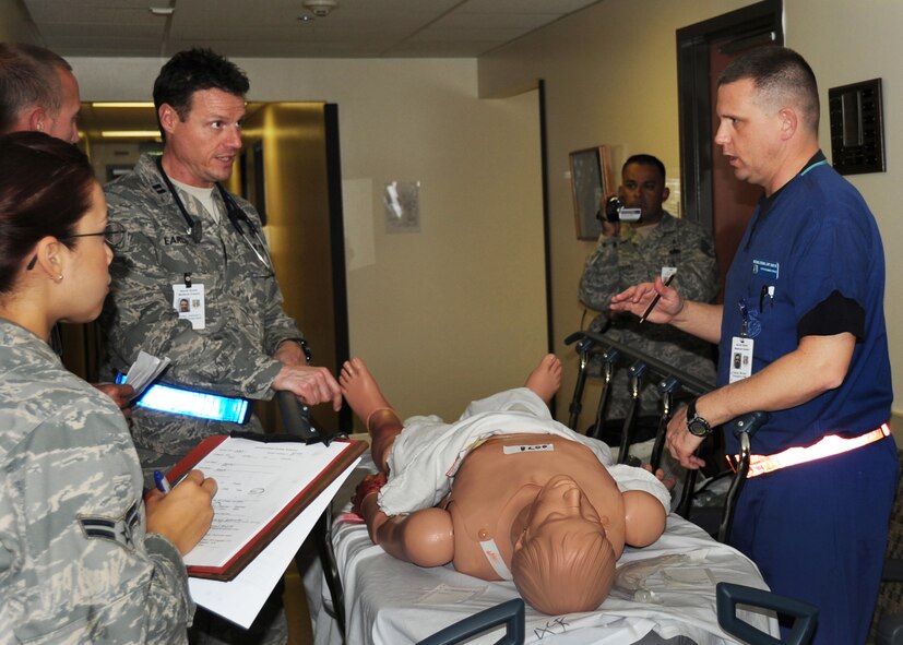 Medical personal, left, Captain Michael Edging and Captain Jamison Early care for the injured as they arrive at David Grant Medical Center during an emergency response exercise at Travis on 12 May 2010. They are both members of the 60th Medical Operations Squadron.  (U.S. Air Force photo by Civ/Jay Trottier)