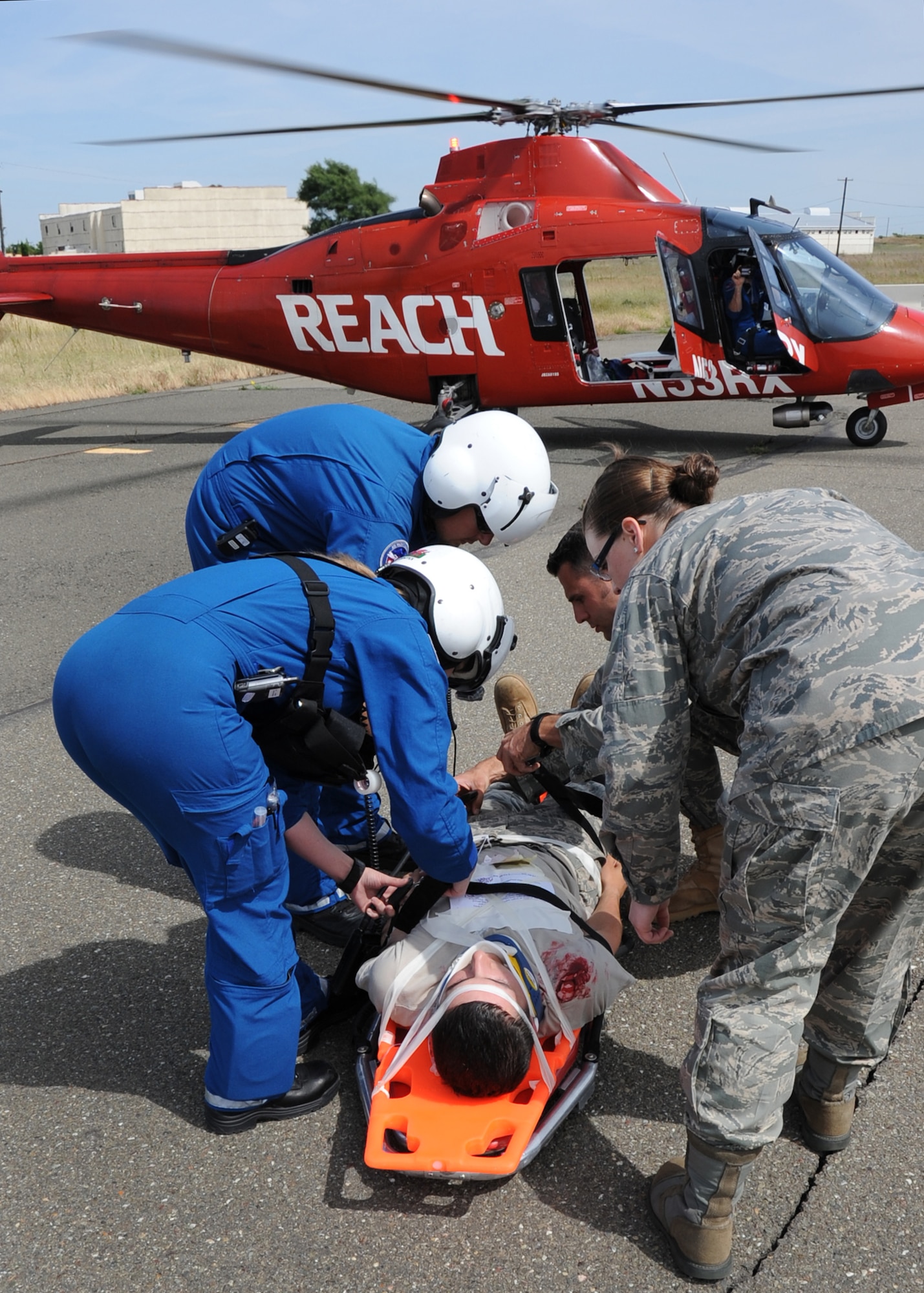 During an emergency response exercise at Travis Air Force Base on 12 May 2010 a local civilian air ambulance and military medical personal work together to transport a simulated patient.  (U.S. Air Force photo by Civ/Jay Trottier)