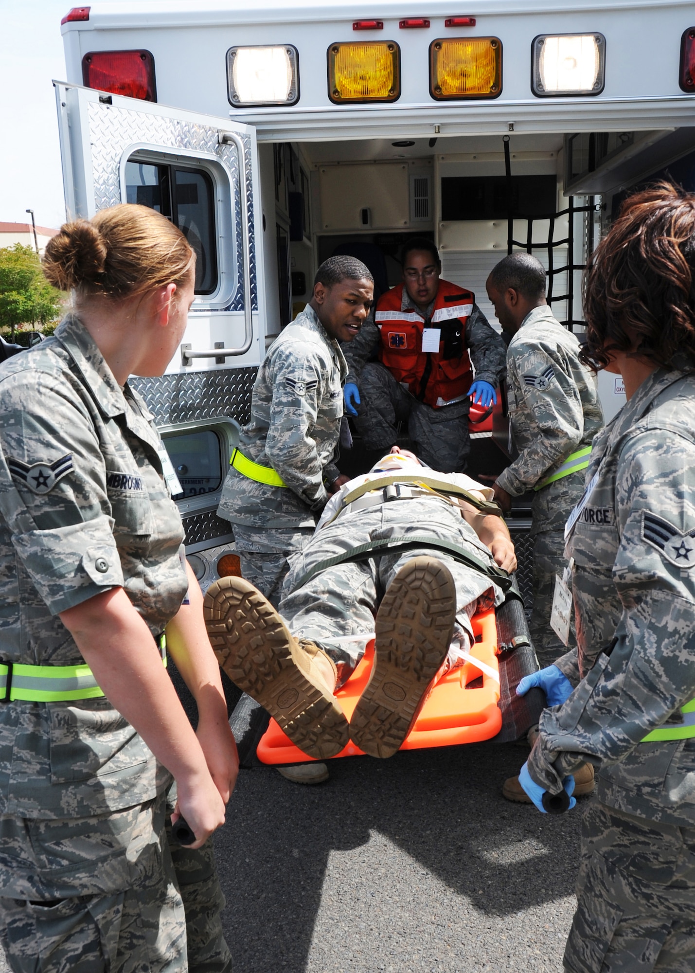 During  an emergency response exercise at Travis Air Force Base, California medical emergency response personal work together to transport a simulated victim to a waiting ambulance. (U.S. Air Force photo by Civ/Jay Trottier)