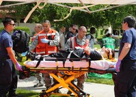 Medical personal and local civilian emergency organizations provide care to simulated victims during an emergency response exercise at Travis Air Force Base, California on 12 May 2010. (U.S. Air Force photo by Civ/Jay Trottier)