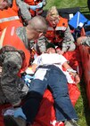 Travis medical personal, left, Airman First Class Chris Dixon member of the Medical Operations Squadron and Captain Jessica Castro, member of the 60th Aerospace Medicine Squadron provide care to simulated victims during an emergency response exercise at Travis Air Force Base, California on 12 May 2010. (U.S. Air Force photo by Civ/Jay Trottier)