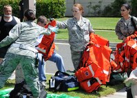 Technical Sergeant Natalie Johnson, member of the 60th Operations Support Squadron hands out vests as the emergency medical team sets up a triage location during a Travis Air Force Base, California response exercise on 12 May 2010.  (U.S. Air Force photo by Civ/Jay Trottier)