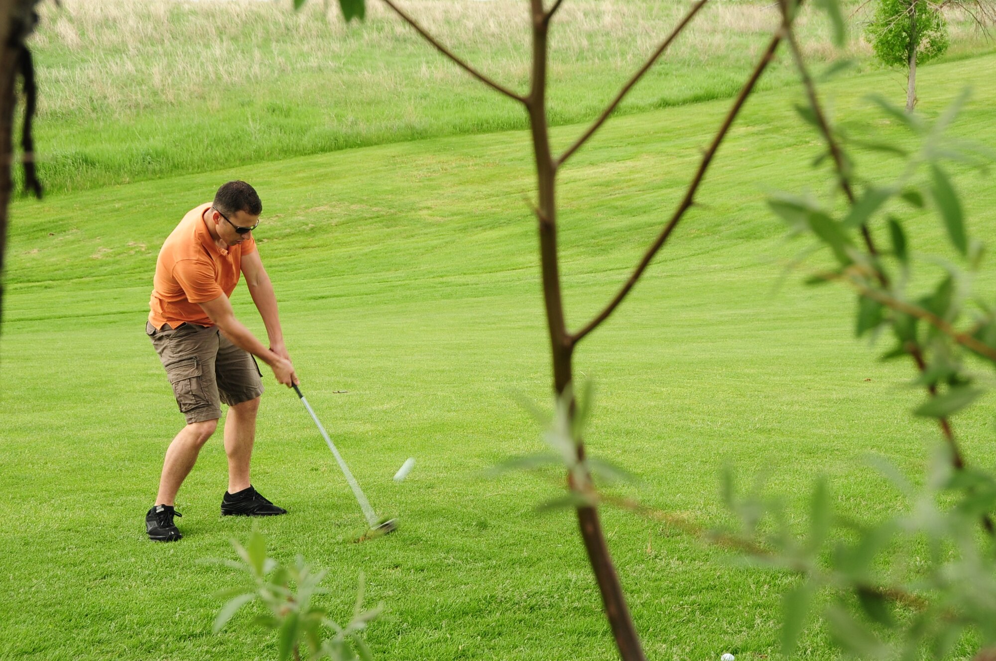 ELLSWORTH AIR FORCE BASE, S.D. -- Senior Airman Kurt Meliet, Air Force Financial Services Center Air Mobility Command relocation technician, chips a golf ball onto the green during a golf tournament, June 4.  The Diamond in the Rough golf tournament was sponsored by the First Sergeant's Association to boost. (U.S. Air Force photo/Airman 1st Class Anthony Sanchelli)