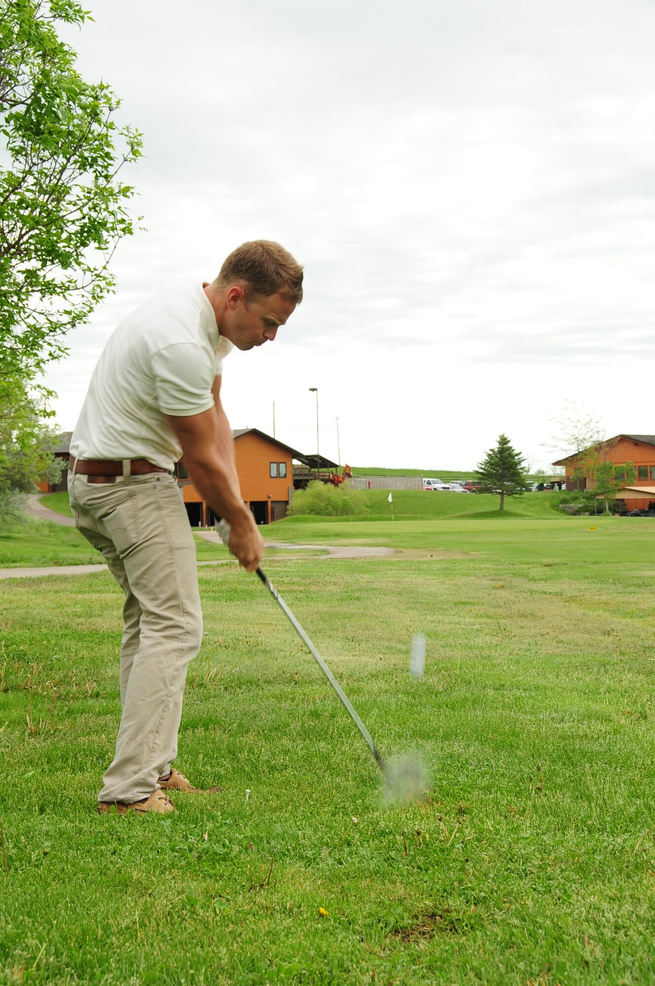 ELLSWORTH AIR FORCE BASE, S.D. -- Airman 1st Class Evan McPhail, 28th Maintenance Squadron avionics technician, strikes the ball during the Diamond in the Rough golf tournament, June 4.  The tournament was sponsored by the First Sergeant's Association as a morale booster. (U.S. Air Force photo/Airman 1st Class Anthony Sanchelli)
