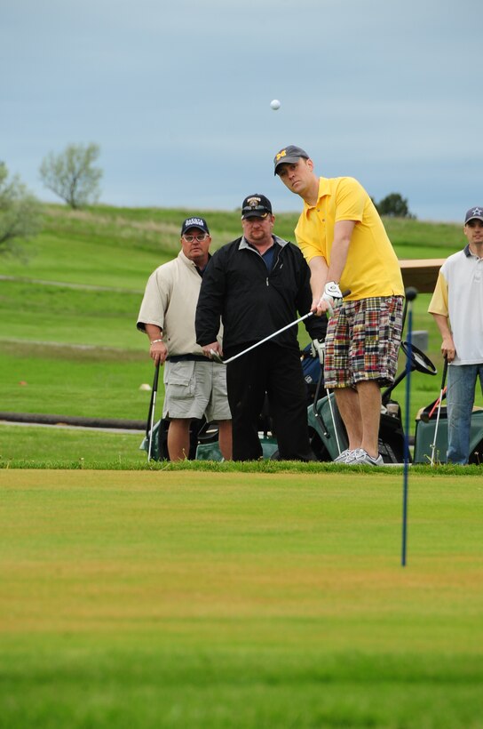 ELLSWORTH AIR FORCE BASE, S.D. -- Tech. Sgt. Bradley Reeves, 28th Operation Support Squadron training manager, hits a golf ball during a chipping competition, June 4.  The chipping competition was the second event during the Diamond in the Rough golf tournament sponsored by the First Sergeant's Association. (U.S. Air Force photo/Airman 1st Class Anthony Sanchelli)
