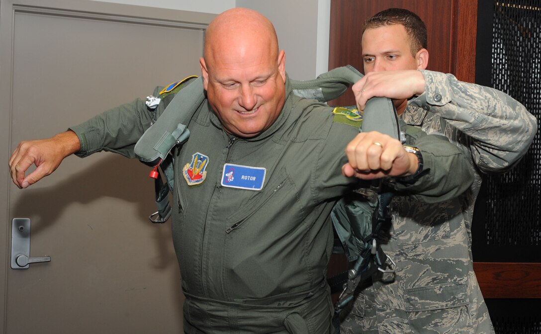 LANGLEY AIR FORCE BASE, Va –  Staff Sgt. William Schierer, 71st Fighter Squadron aircraft flightcrew journeyman, helps Steve Mallon, Langley Civic Leaders Association president, don flight gear prior to his orientation flight aboard an F-15 Eagle June 3.  The association addresses the need for communication between Langley personnel and the local community and supports several base activities and programs. (U.S. Air Force photo/Staff Sgt. Barry Loo)