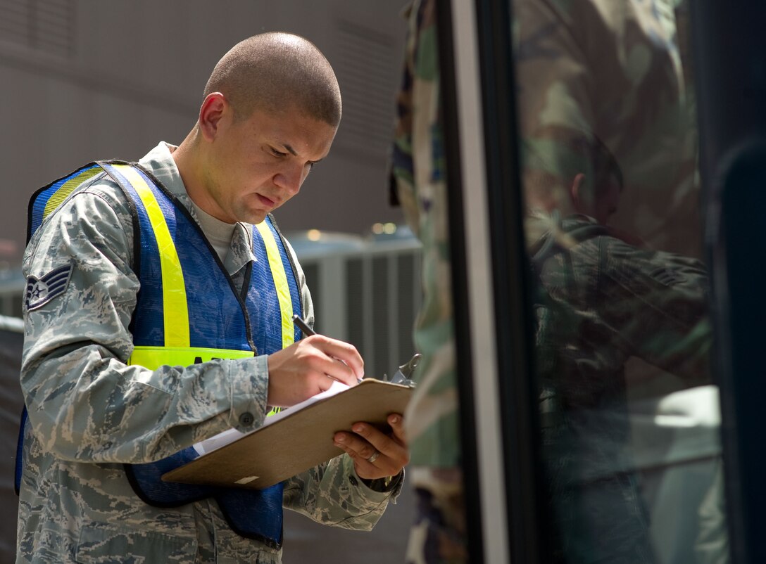 LANGLEY AIR FORCE BASE, Va. – Staff Sgt. Joe Garcia, 633d Communications Squadron Air Passenger Terminal noncommissioned officer in charge, takes accountability of arriving passengers prior to their deployment to Andersen Air Force Base, Guam, June 2. The deployment, which will last approximately four months, is a prudent measure to maintain a credible deterrent posture and presence for the region and demonstrate a continued U.S. commitment to fulfilling security responsibilities throughout the Western Pacific. (U.S. Air Force photo/Staff Sgt. Barry Loo)