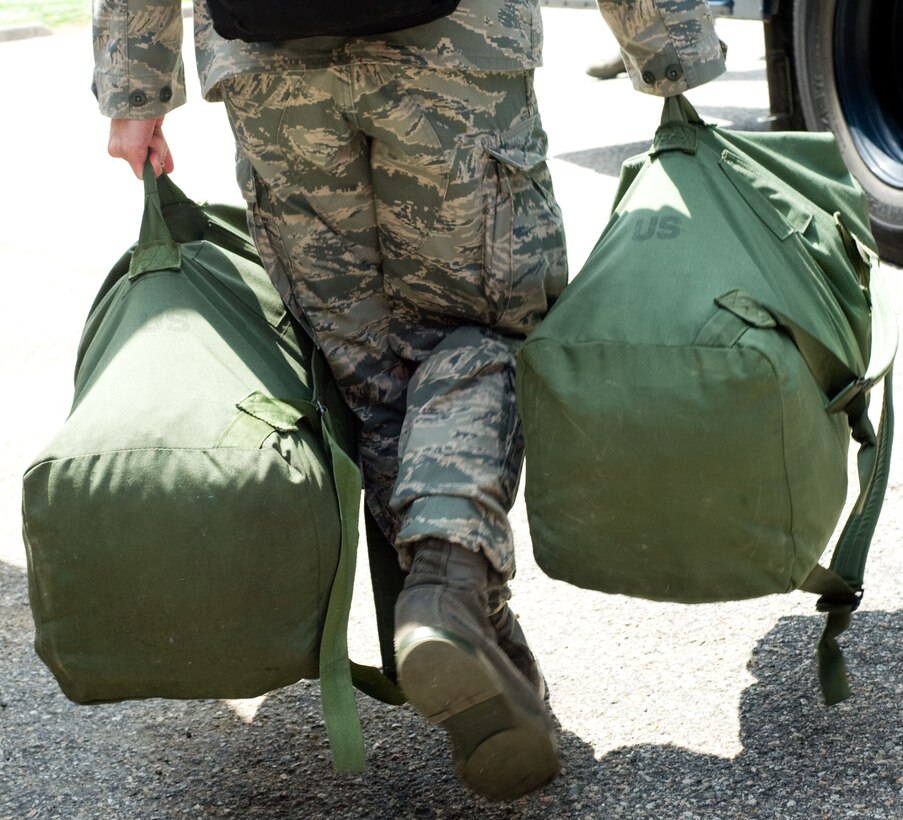 LANGLEY AIR FORCE BASE, Va. – A Langley Airman carries duffle bags prior to his deployment to Andersen Air Force Base, Guam, June 2. The deployment, which will last approximately four months, is a prudent measure to maintain a credible deterrent posture and presence for the region and demonstrate a continued U.S. commitment to fulfilling security responsibilities throughout the Western Pacific. (U.S. Air Force photo/Staff Sgt. Barry Loo)