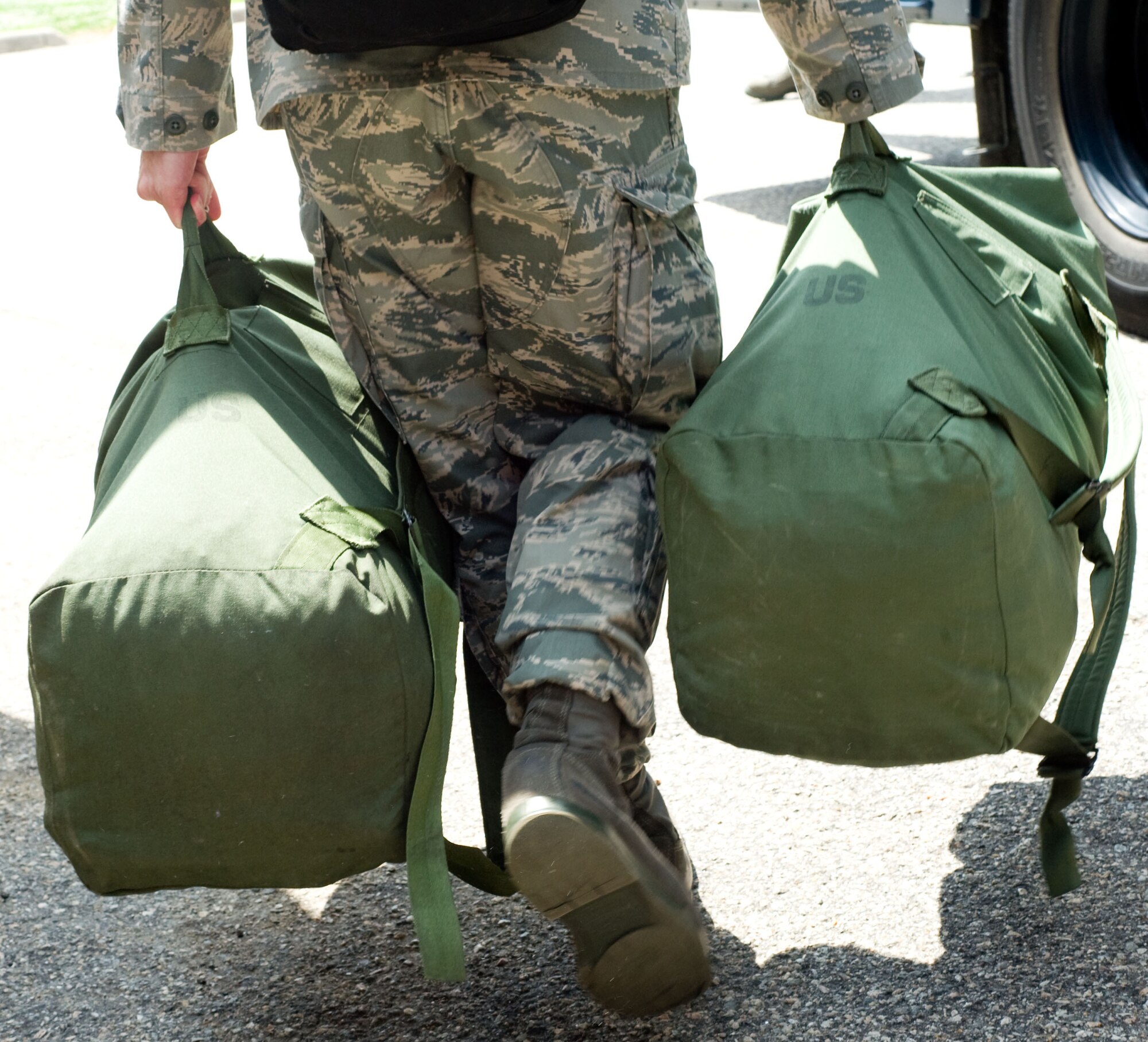 LANGLEY AIR FORCE BASE, Va. – A Langley Airman carries duffle bags prior to his deployment to Andersen Air Force Base, Guam, June 2. The deployment, which will last approximately four months, is a prudent measure to maintain a credible deterrent posture and presence for the region and demonstrate a continued U.S. commitment to fulfilling security responsibilities throughout the Western Pacific. (U.S. Air Force photo/Staff Sgt. Barry Loo)