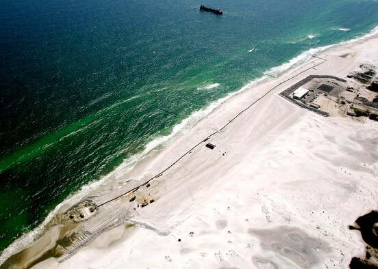 An aerial view shows a dredge boat off the coastline at Test Area A-3 on Eglin’s portion of Santa Rosa Island. Over $112 million in construction projects are underway to protect the mission facilities on the island.  The "armoring" phase of the project is scheduled to be completed by mid-June.  (Courtesy photo.)