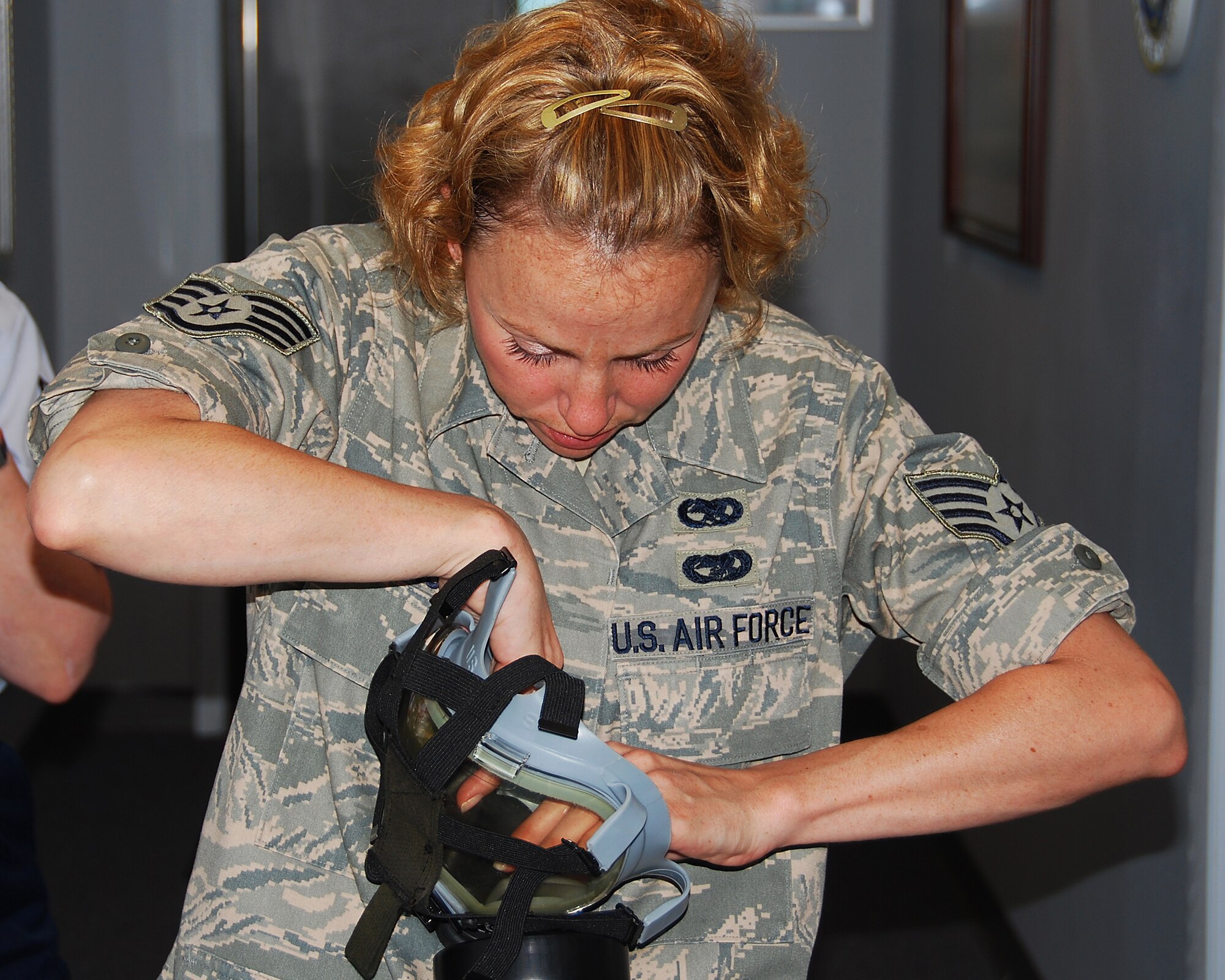 JOINT BASE MCGUIRE-DIX-LAKEHURST, NJ -- Staff Sgt. Amanda Sensel, 514th Air Mobility Wing Safety, inspects her gas mask as part of annual block training requirements here June 3, 2010. During block training, Reserve Airmen spend four days reviewing and practicing basic skills in addition to completing mandatory ancillary training. (U.S. Air Force photo/Staff Sgt. Shawn J. Jones)