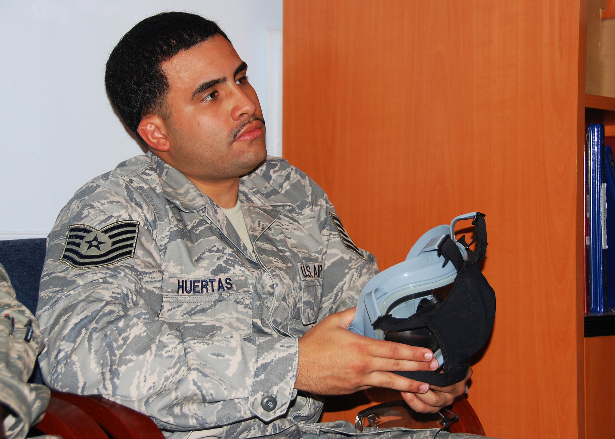 JOINT BASE MCGUIRE-DIX-LAKEHURST, NJ -- Technical Sgt. Jesse Huertas, 514th Air Mobility Wing Commanders Support Staff, observes during a demonstration of proper gas mask-inspecting procedures as part of annual block training requirements here June 3, 2010. During block training, Reserve Airmen spend four days reviewing and practicing basic skills in addition to completing mandatory ancillary training. (U.S. Air Force photo/Staff Sgt. Shawn J. Jones)