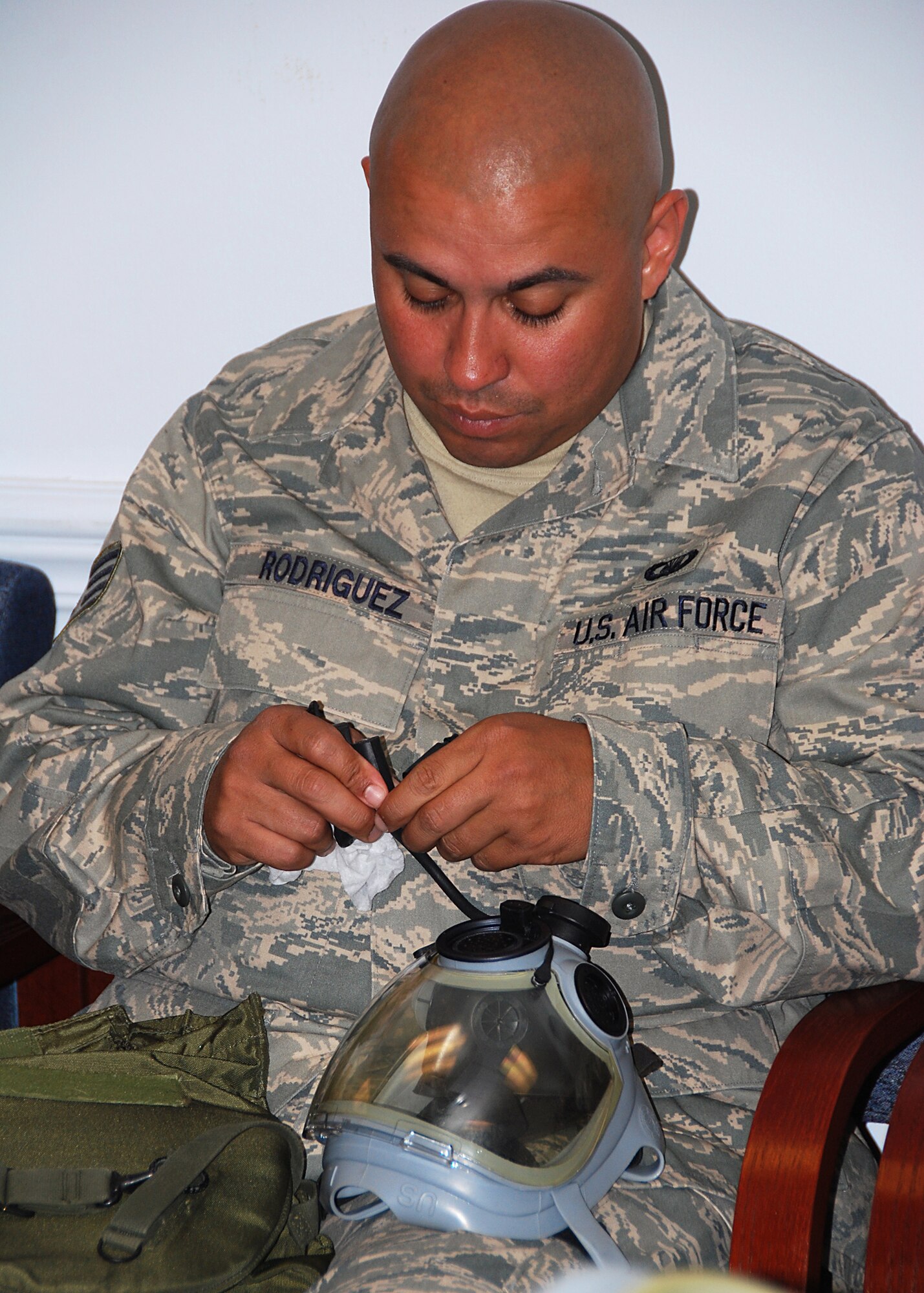 JOINT BASE MCGUIRE-DIX-LAKEHURST, NJ -- Staff Sgt. Raul Rodriguez, 514th Air Mobility Wing Chapel, inspects his gas mask as part of annual block training requirements here June 3, 2010. During block training, Reserve Airmen spend four days reviewing and practicing basic skills in addition to completing mandatory ancillary training. (U.S. Air Force photo/Staff Sgt. Shawn J. Jones)