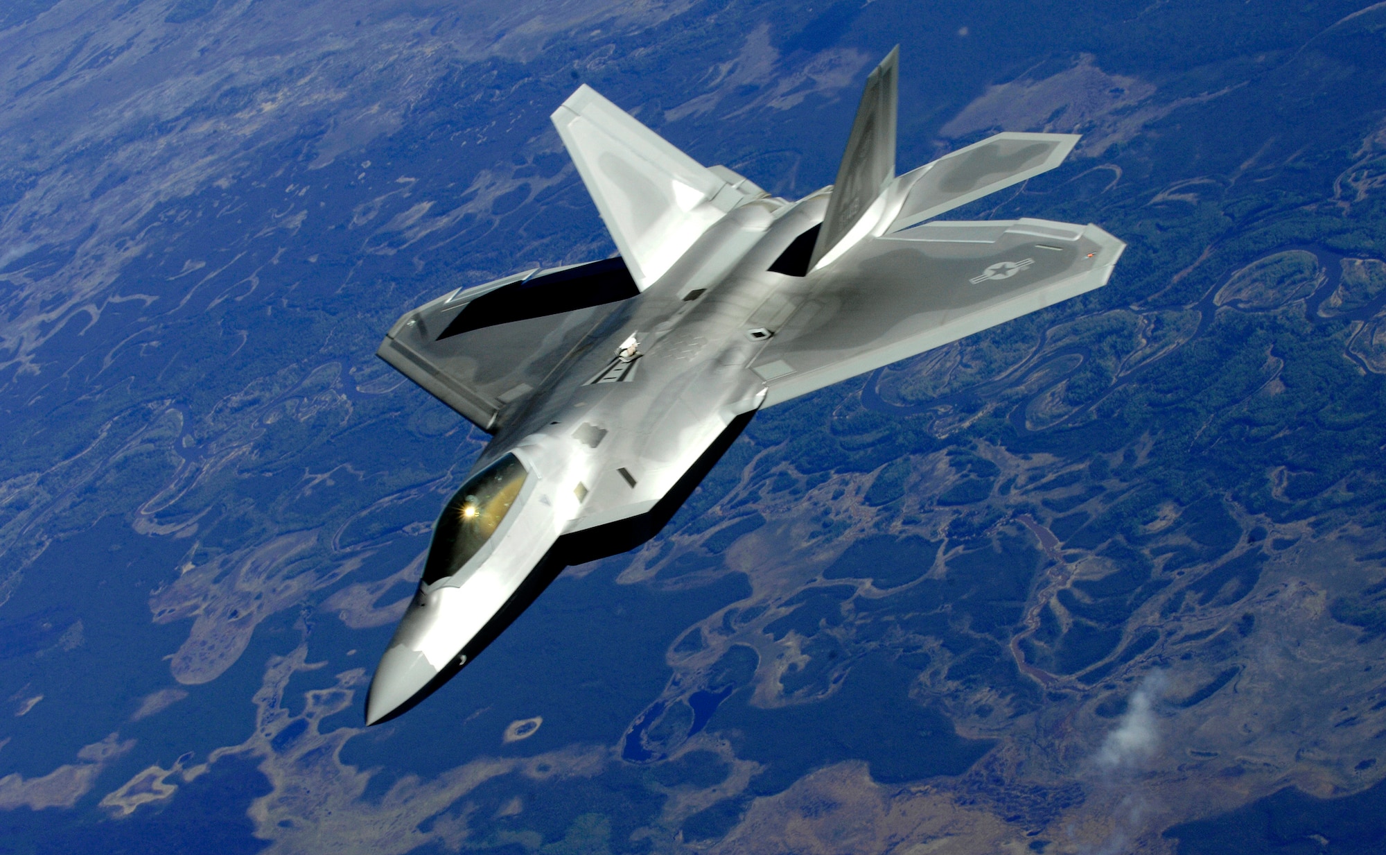 An F-22 Raptor from Elmendorf Air Force Base pulls alongside a KC-135 Stratotanker, simulating a Boeing 747, after federal air marshals subdue a simulated terrorist onboard the plane during Arctic Fencing Inter-Agency Arrow 2010 field training exercise May 26, 2010, at Elmendorf Air Force Base, Alaska. (U.S. Air Force photo/Staff Sgt. Brian Ferguson)