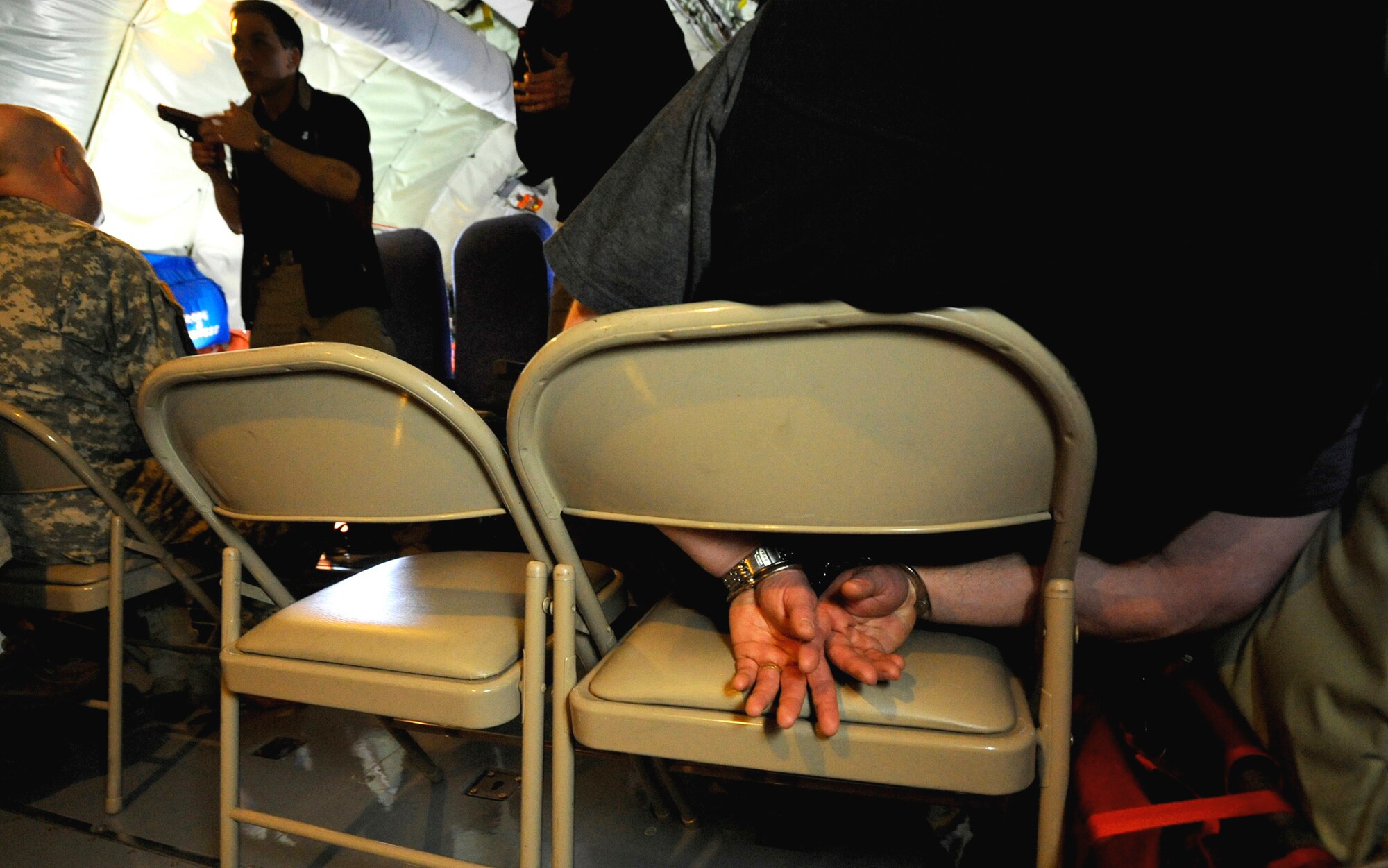 Federal air marshals take control of a simulated situation after a man threatened passengers onboard a plane during Arctic Fencing Interagency Arrow 2010 field training exercise May 26, 2010, at Elmendorf Air Force Base, Alaska. (U.S. Air Force photo/Staff Sgt. Brian Ferguson)