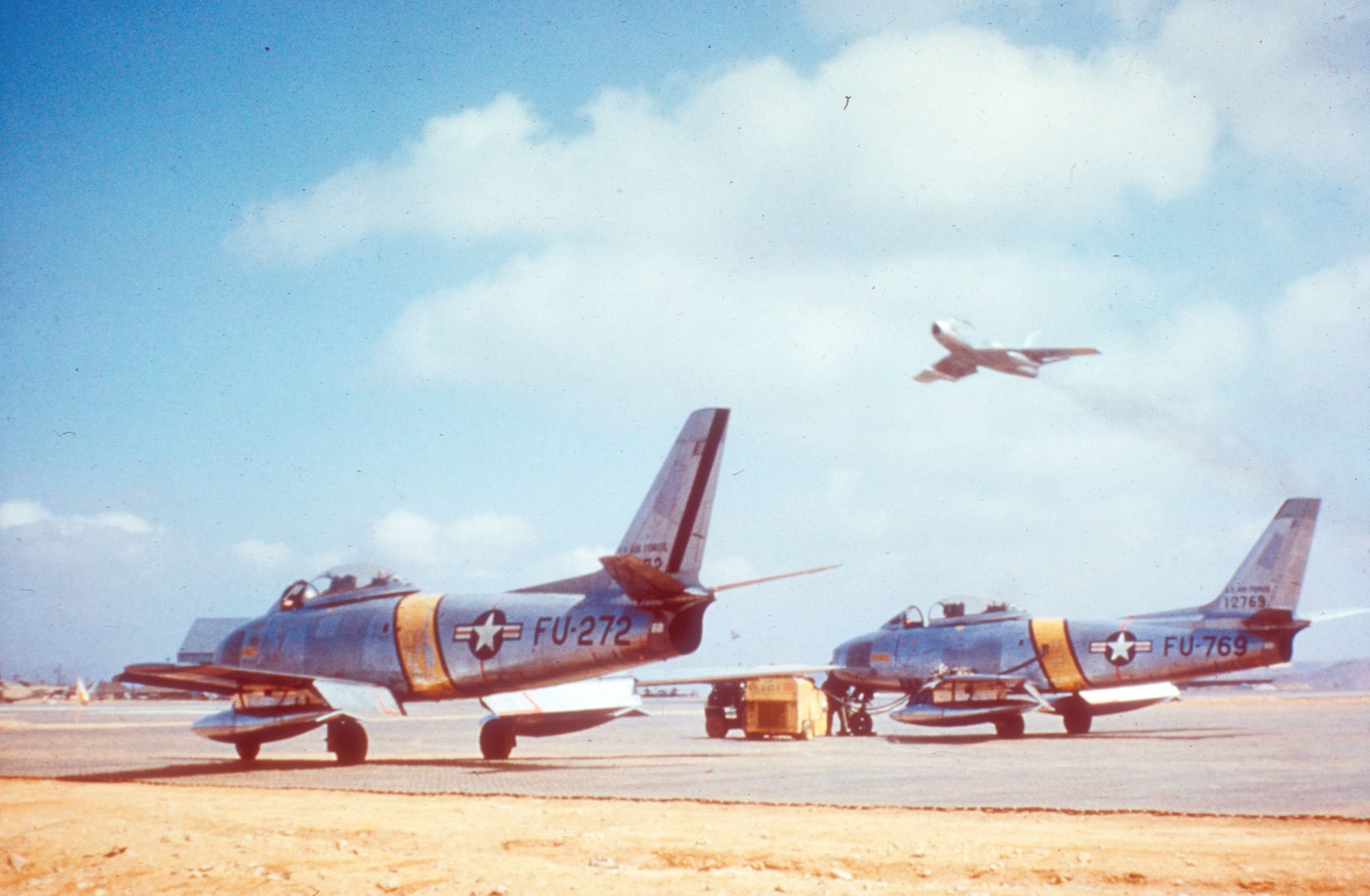 F-86Es in April 1952. In late 1951 F-86 units applied yellow bands on the fuselage and wings as a recognition aid. Previously, these markings were black and white stripes. (U.S. Air Force photo)