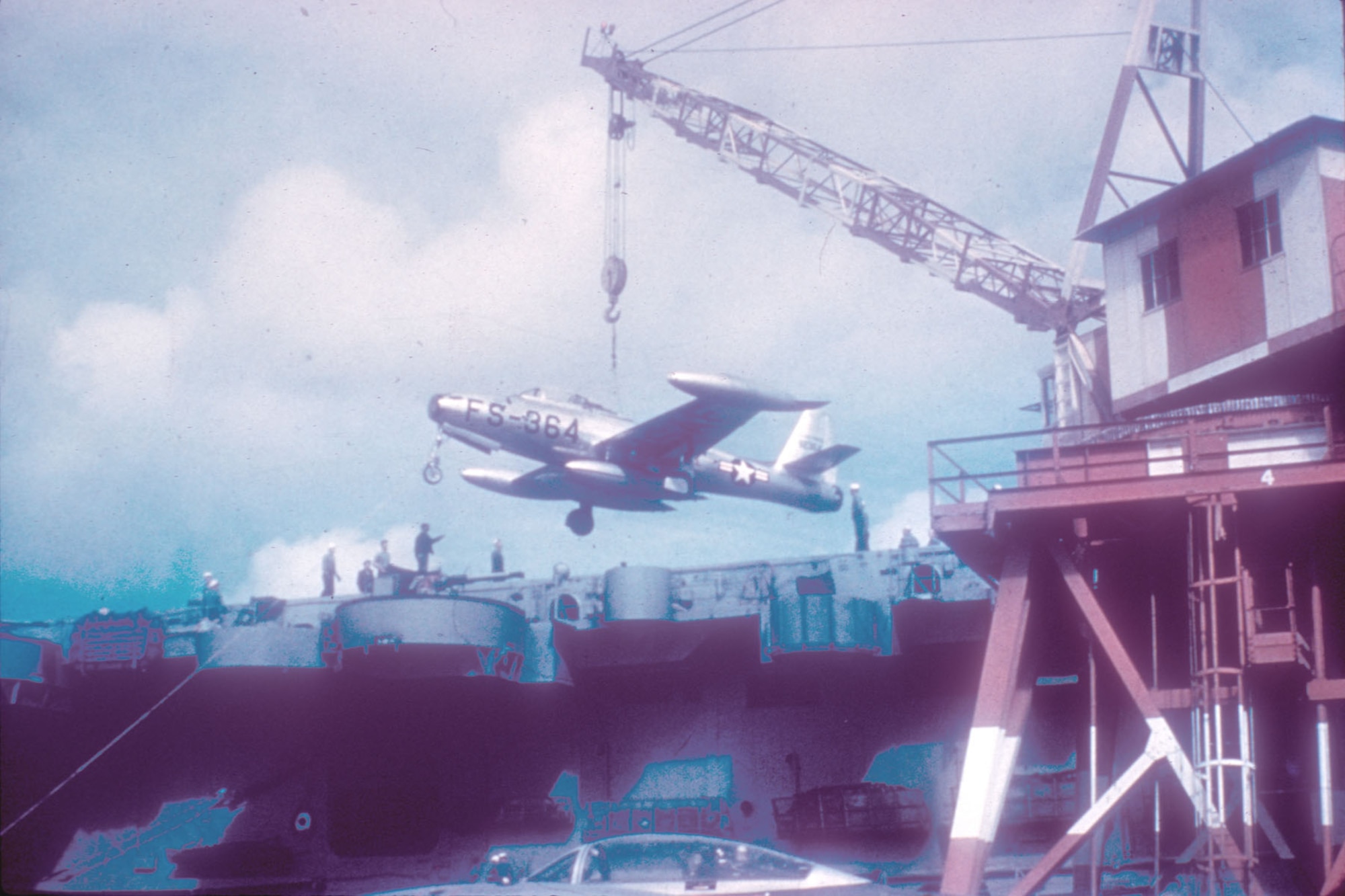 In November 1950 the Air Force sent the highly-experienced 27th Fighter Escort Group to Korea to protect B-29 bombers from MiG-15 attacks. Pictured here are 27th FEG F-84s being loaded onto the carrier USS Bataan for shipment to Korea. (U.S. Air Force photo)