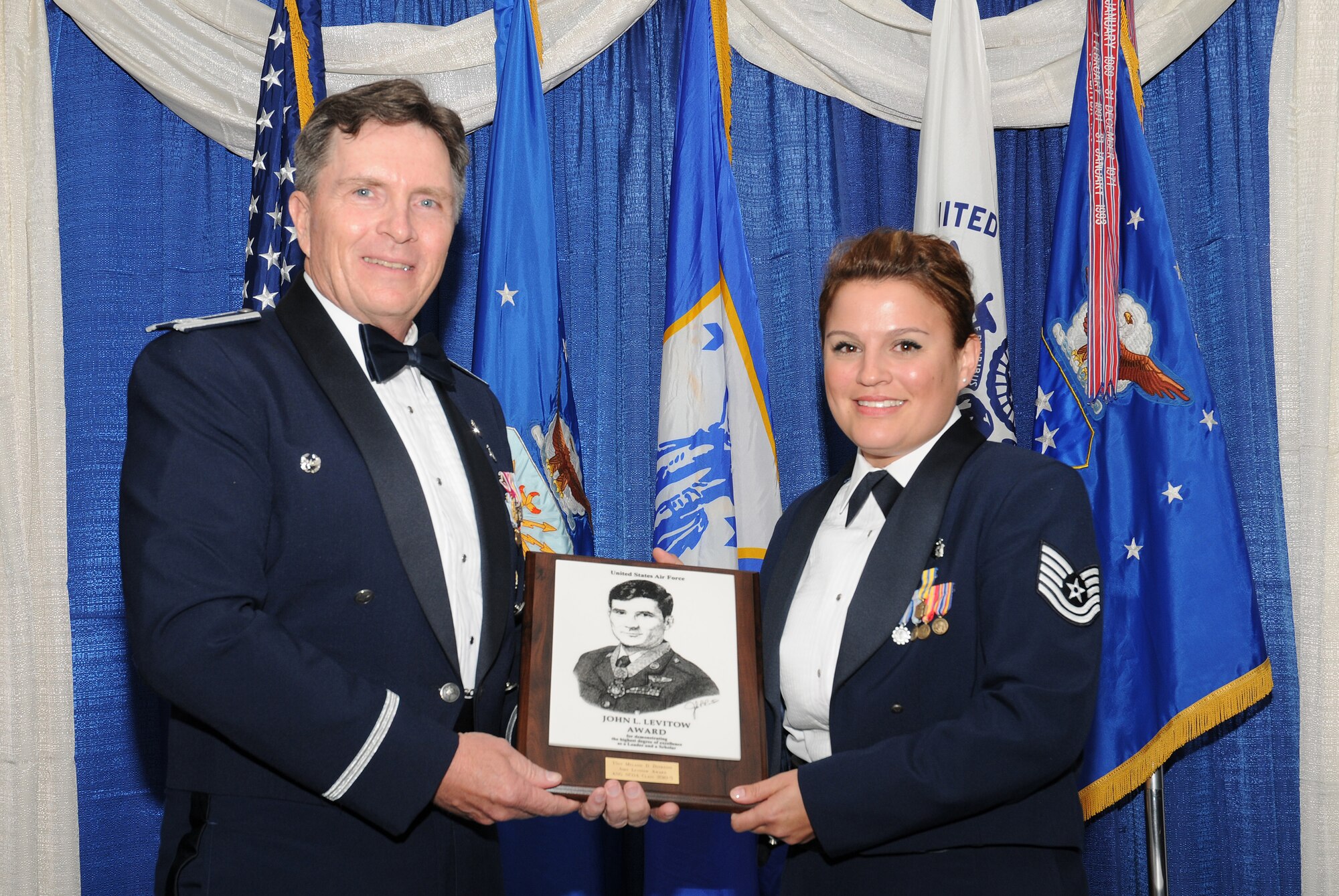 McGHEE TYSON AIR NATIONAL GUARD BASE, Tenn. --  Air Force Tech. Sgt. Melanie D. Dufresne, right, the NCOIC of the ambulatory procedures unit, 88th Surgical Operations Squadron, Wright-Patterson AFB, Ohio, receives the John L. Levitow honor award for NCO Academy Class 10-5 at The I.G Brown Air National Guard Training and Education Center here from Col. Richard B. Howard, commander, June 2, 2010.  The John L. Levitow award is the highest honor awarded a graduate of any Air Force enlisted professional military education course.  (U.S. Air Force photo by Master Sgt. Kurt Skoglund/Released)