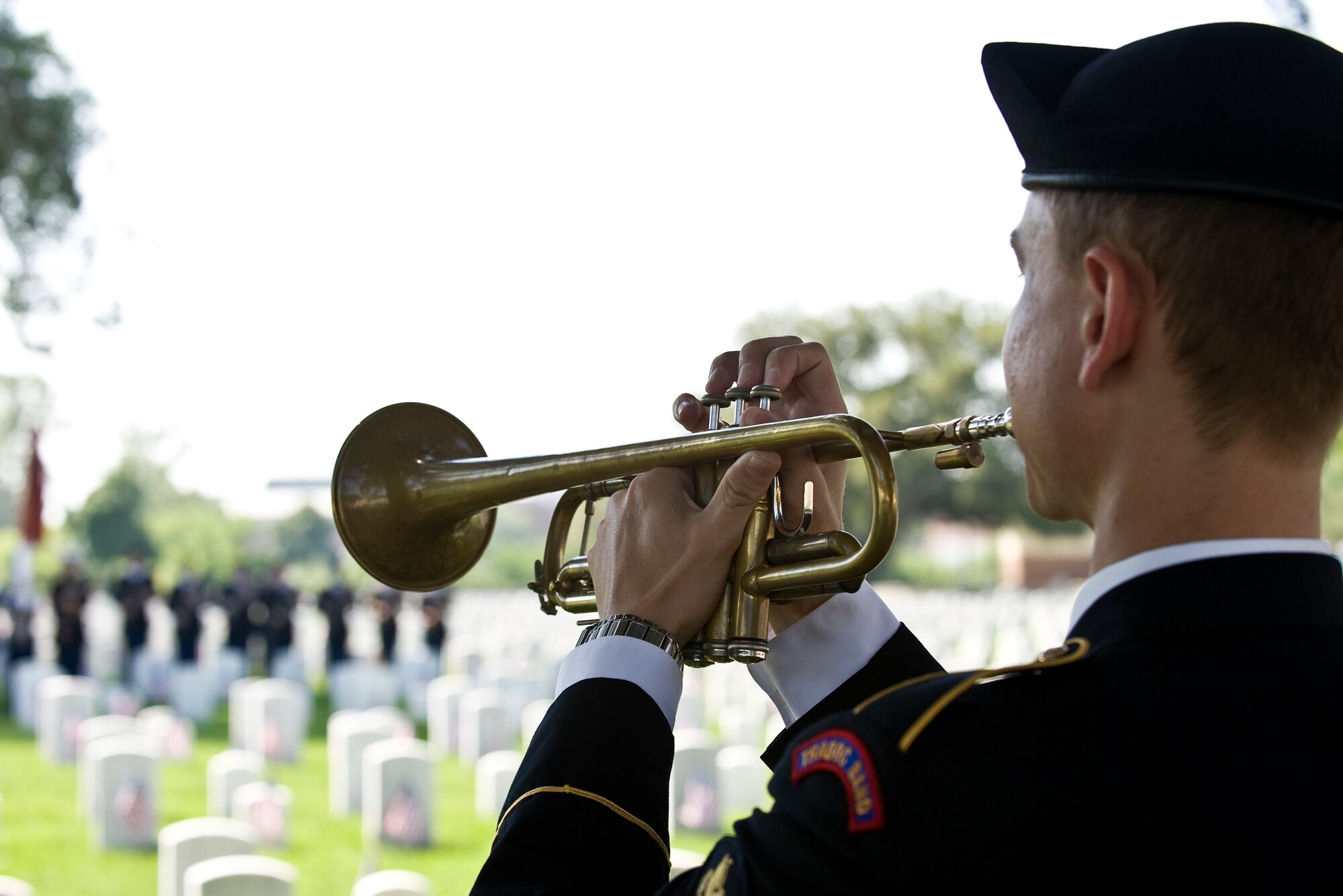 LANGLEY AIR FORCE BASE, Va. -- Spc. Christopher Whitfield, United States Army Training and Doctrine Command Band bugler, plays "Taps" during the Memorial Day Ceremony at Hampton National Cemetery May 31.  The ceremony was held to honor servicemembers lost in the line of duty.  (U.S. Air Force photo/Senior Airman Zachary Wolf)