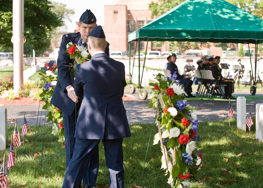 LANGLEY AIR FORCE BASE, Va. -- Col. Donald Kirkland, 633d Air Base Wing commander, and Airman 1st Class Casey Havaich, 1st Aircraft Maintenance Squadron, place a wreath at a headstone during the Memorial Day Ceremony at Hampton National Cemetery May 31.  The ceremony was held to honor servicemembers lost in the line of duty.  (U.S. Air Force photo/Senior Airman Zachary Wolf)