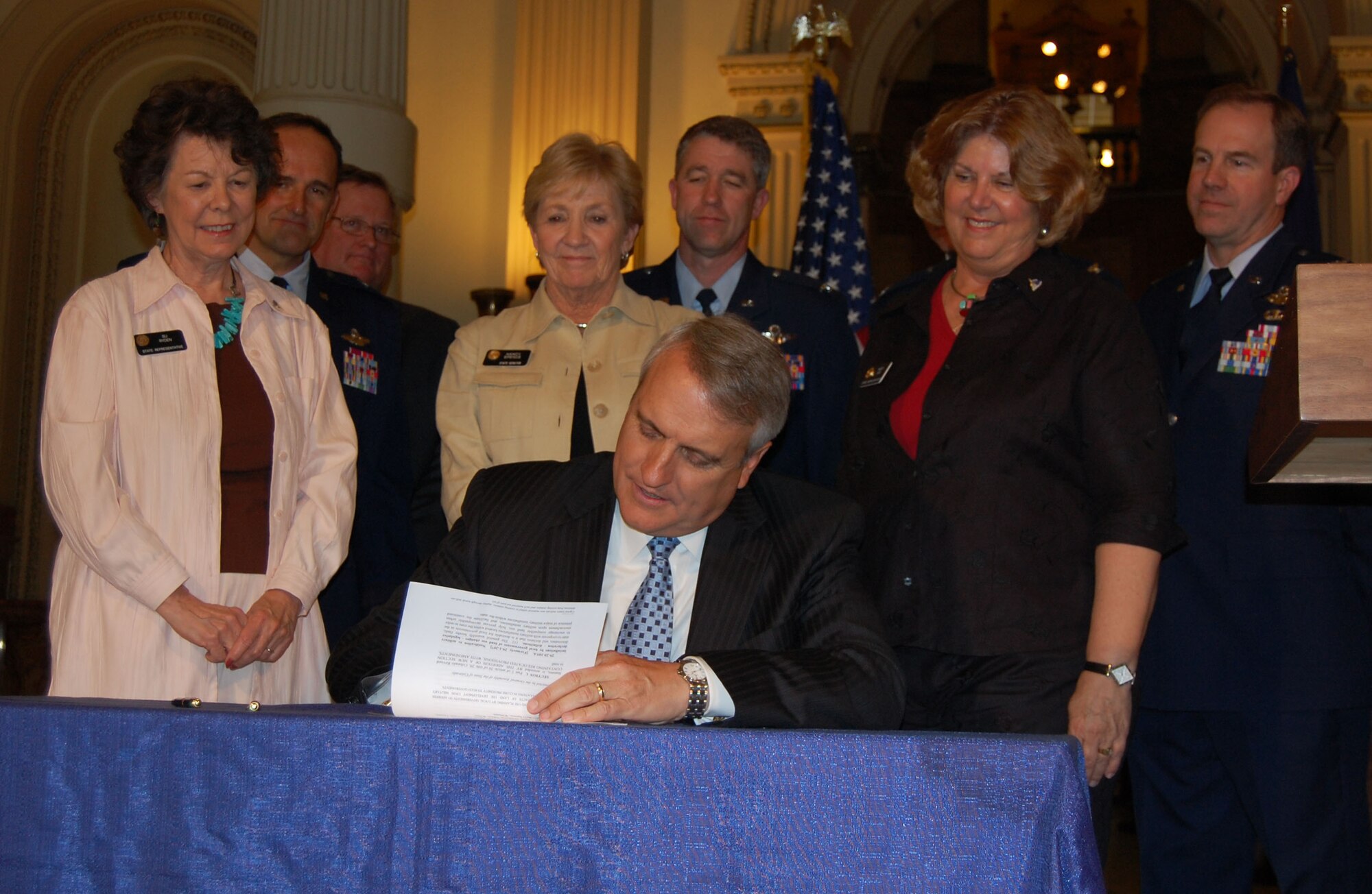 Gov. Bill Ritter signs House Bill 1201. The bill improves cooperation between military installations and government officials on land use, development and zoning issues.