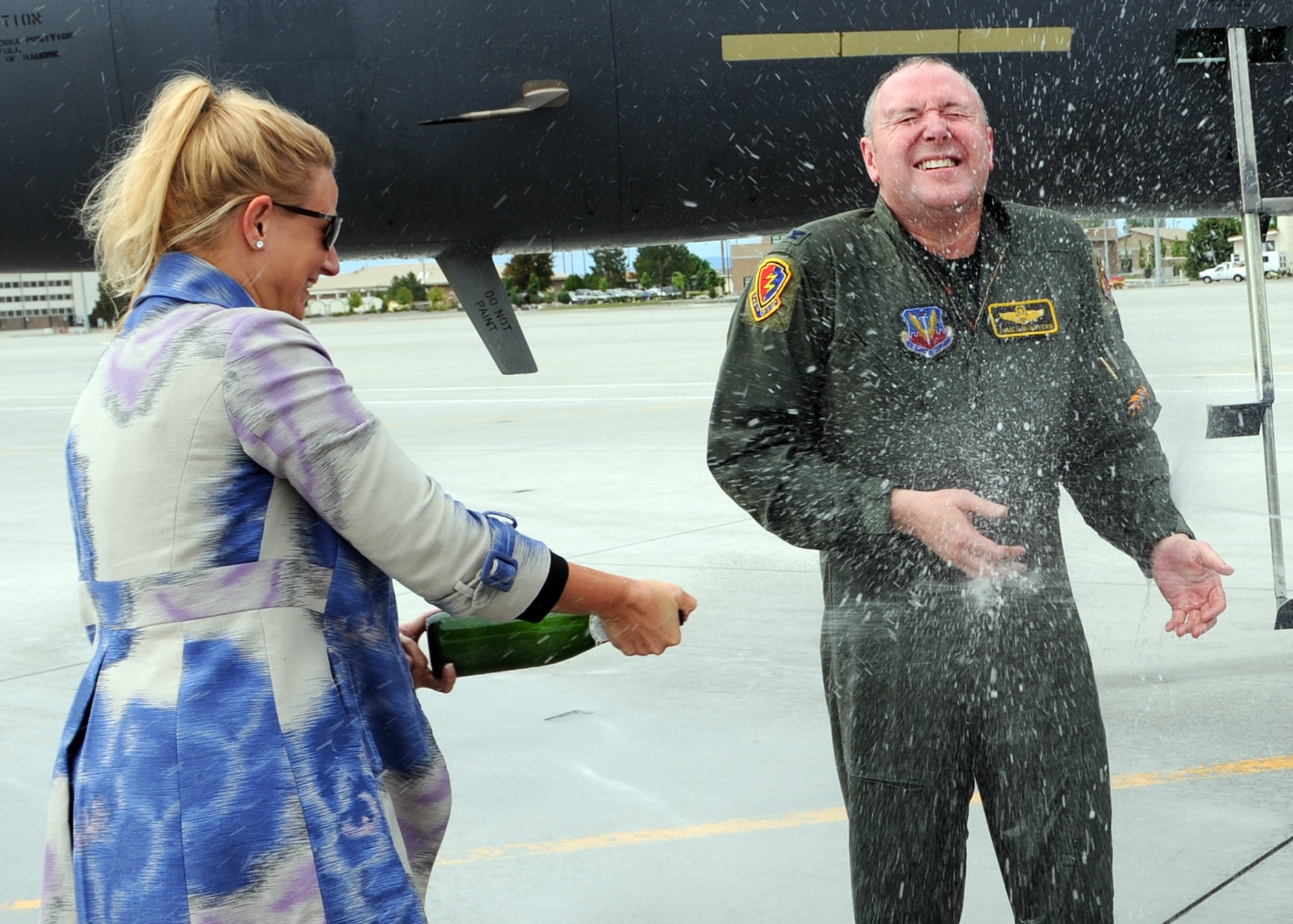 MOUNTAIN HOME AIR FORCE BASE, Idaho – Lisa McGovern sprays her husband, Col. James McGovern, 366th Operations Group commander, with champagne after his final flight in an F-15E Strike Eagle June 2. Colonel McGovern has been selected as the 607th Air and Space Operations Center commander at Osan Air Base, Korea. (U.S. Air Force photo by Airman 1st Class Debbie Lockhart)